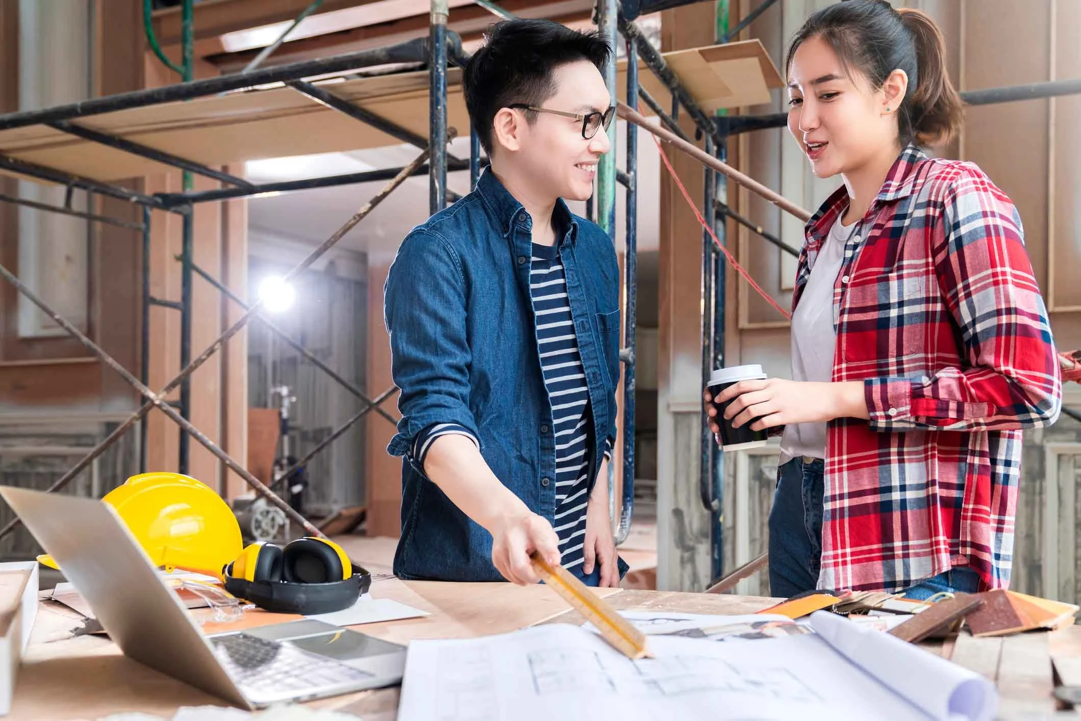Building owner discussing the plan wtih his female employee.