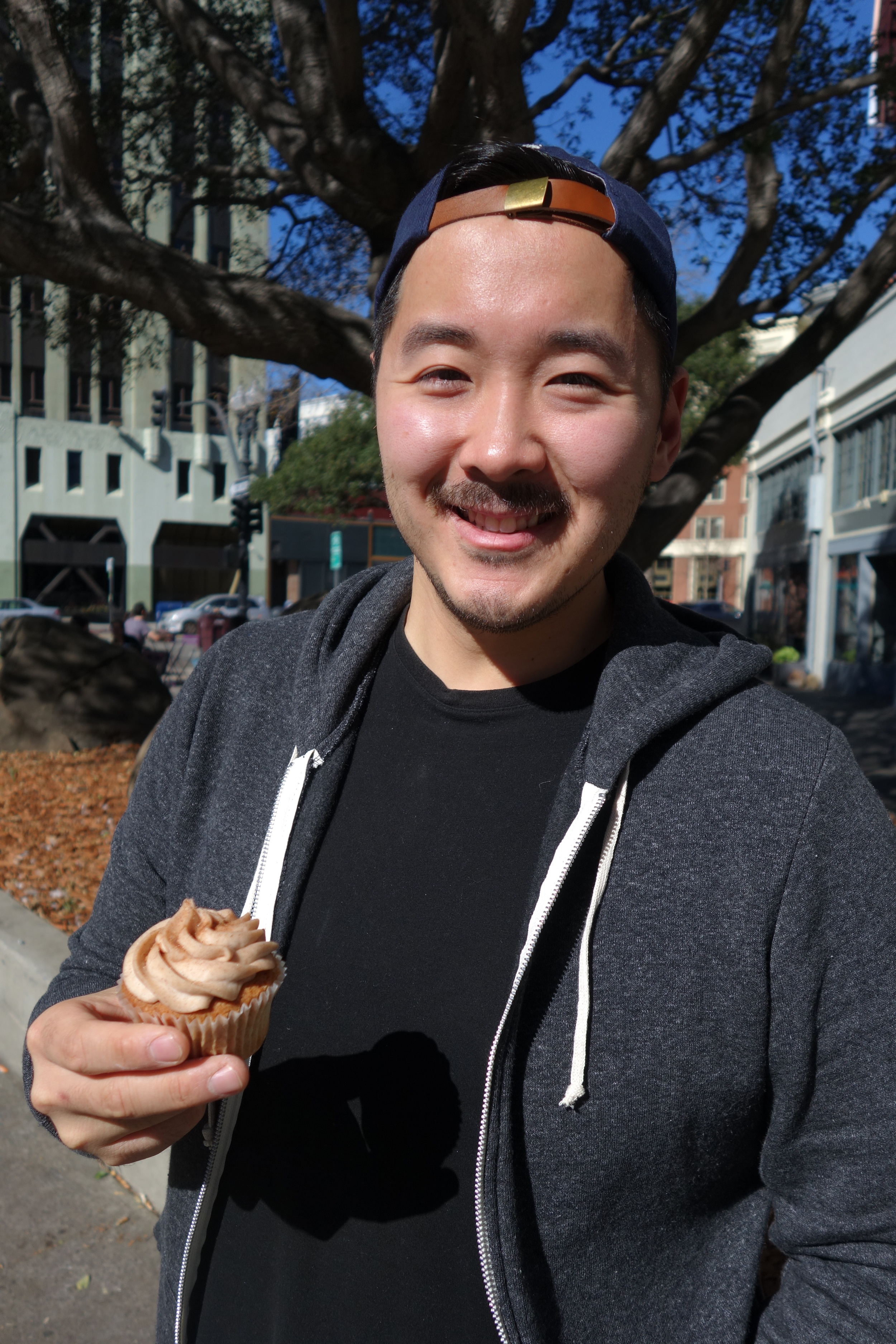 Wenter Shyu holds their best-selling Churro Cupcake just outside Taiwan Bento.