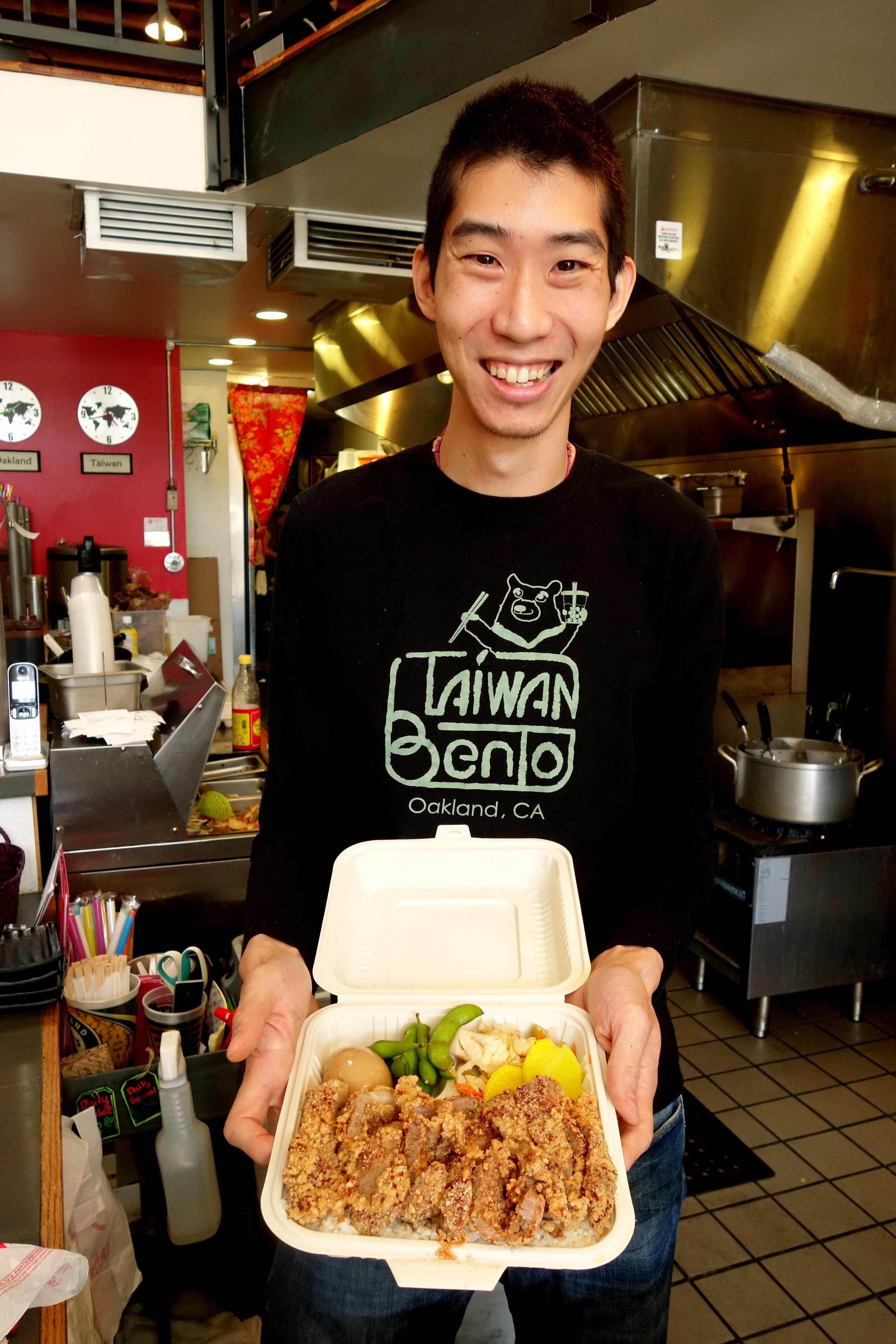 Willy Wang holding their Chicken Bento at Taiwan Bento in Oakland, California. 2016.