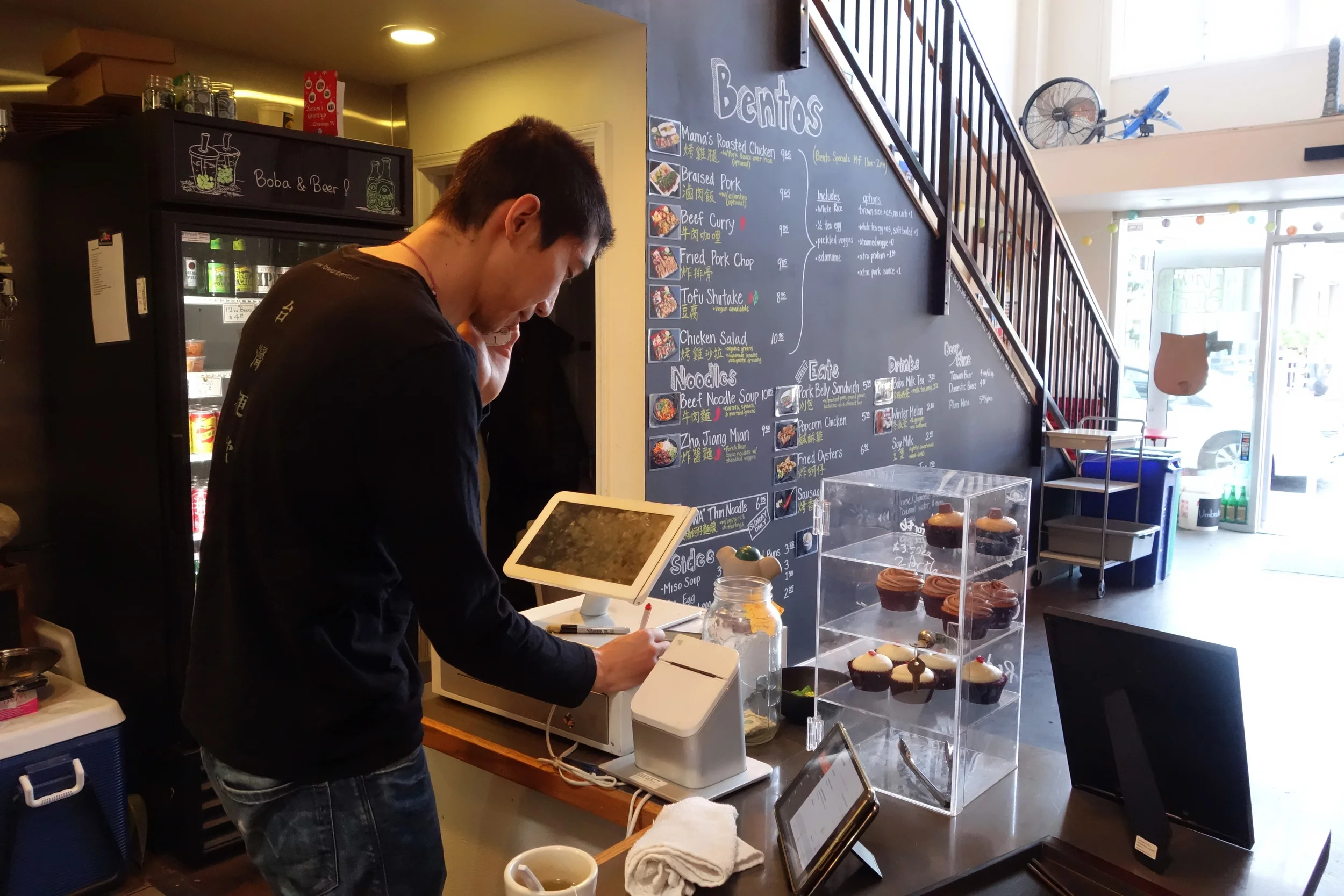 Willy Wang takes an order via phone at Taiwan Bento.