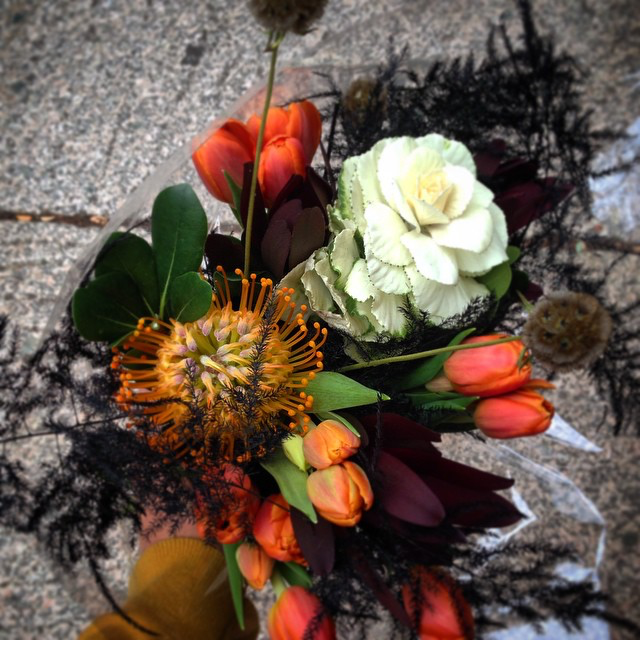 This eerie hand-tied bouquet features fall classics like white kale, scabiosa pods and black feather fern. 