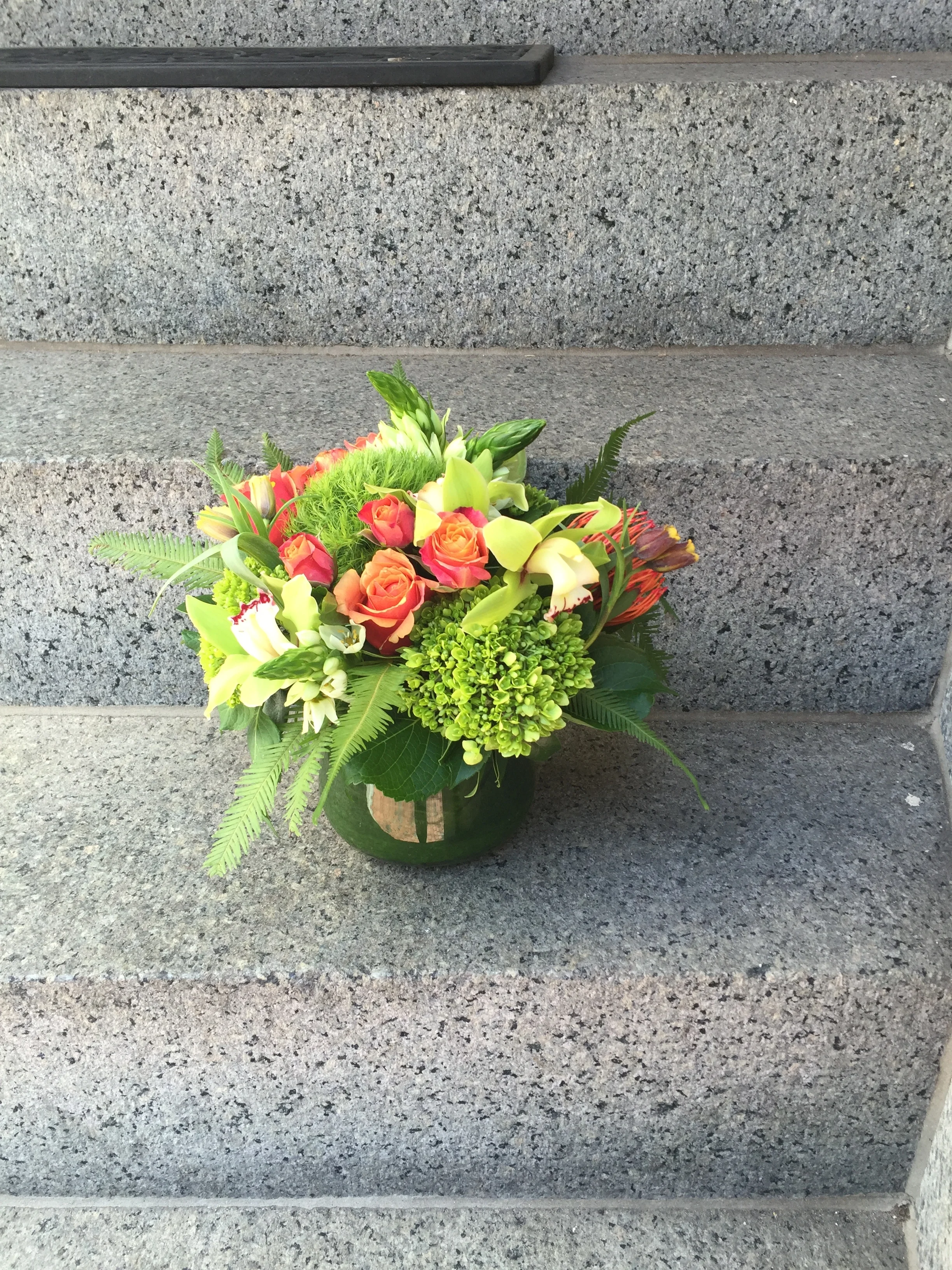Umbrella fern adds a touch of tropical spice to this centerpiece. 