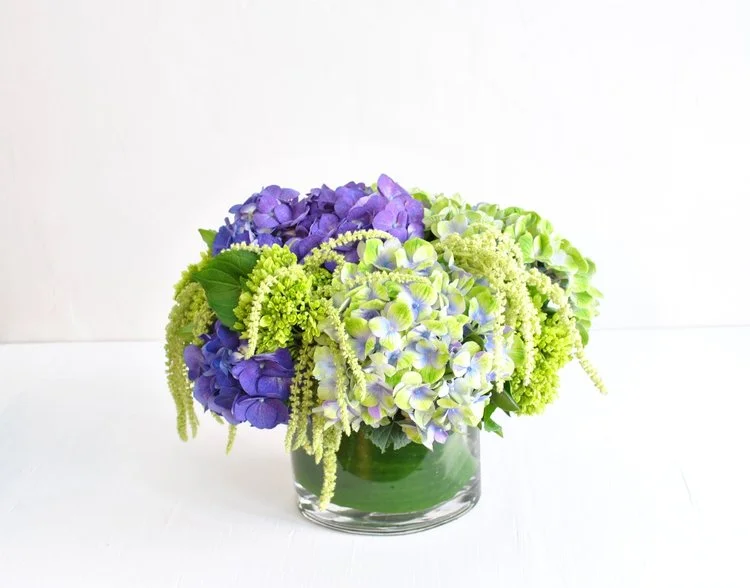 From our latest collection, Nantucket! The epitome of summers on the coast of New England, these gorgeous deep and variegated amethyst Dutch hydrangea pop against chartreuse mini green hydrangea and hanging amaranth. 