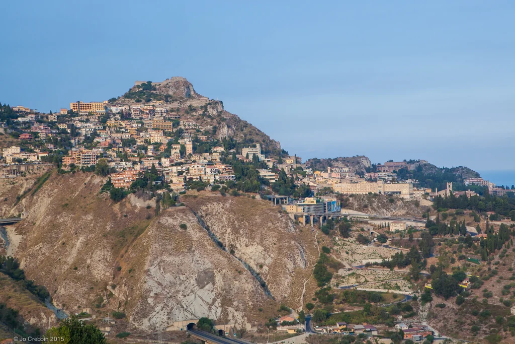 Taormina stands high on cliff overlooking Mediterranean Sea.jpg