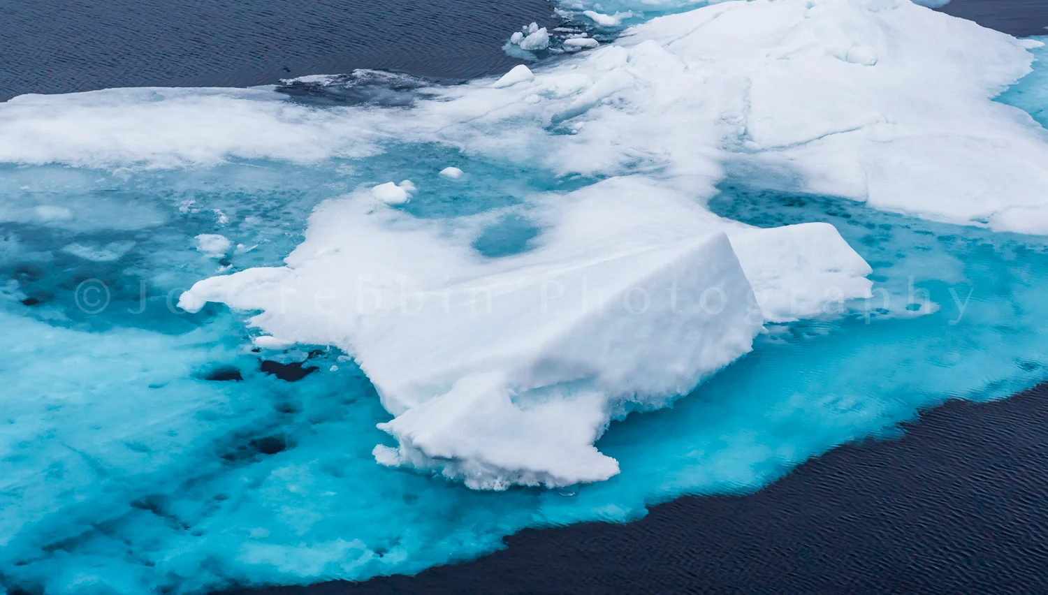 Turquoise blue glacier ice floats in the Arctic.jpg