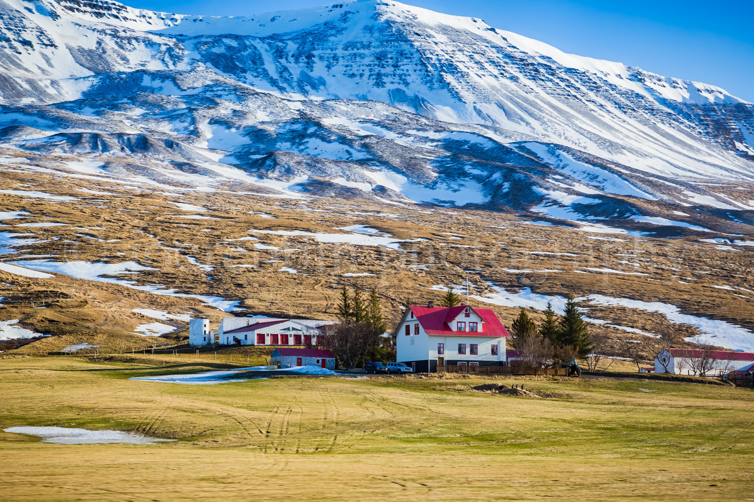 White farmhouse with bright red roof neaar Myvatn in Iceland.jpg