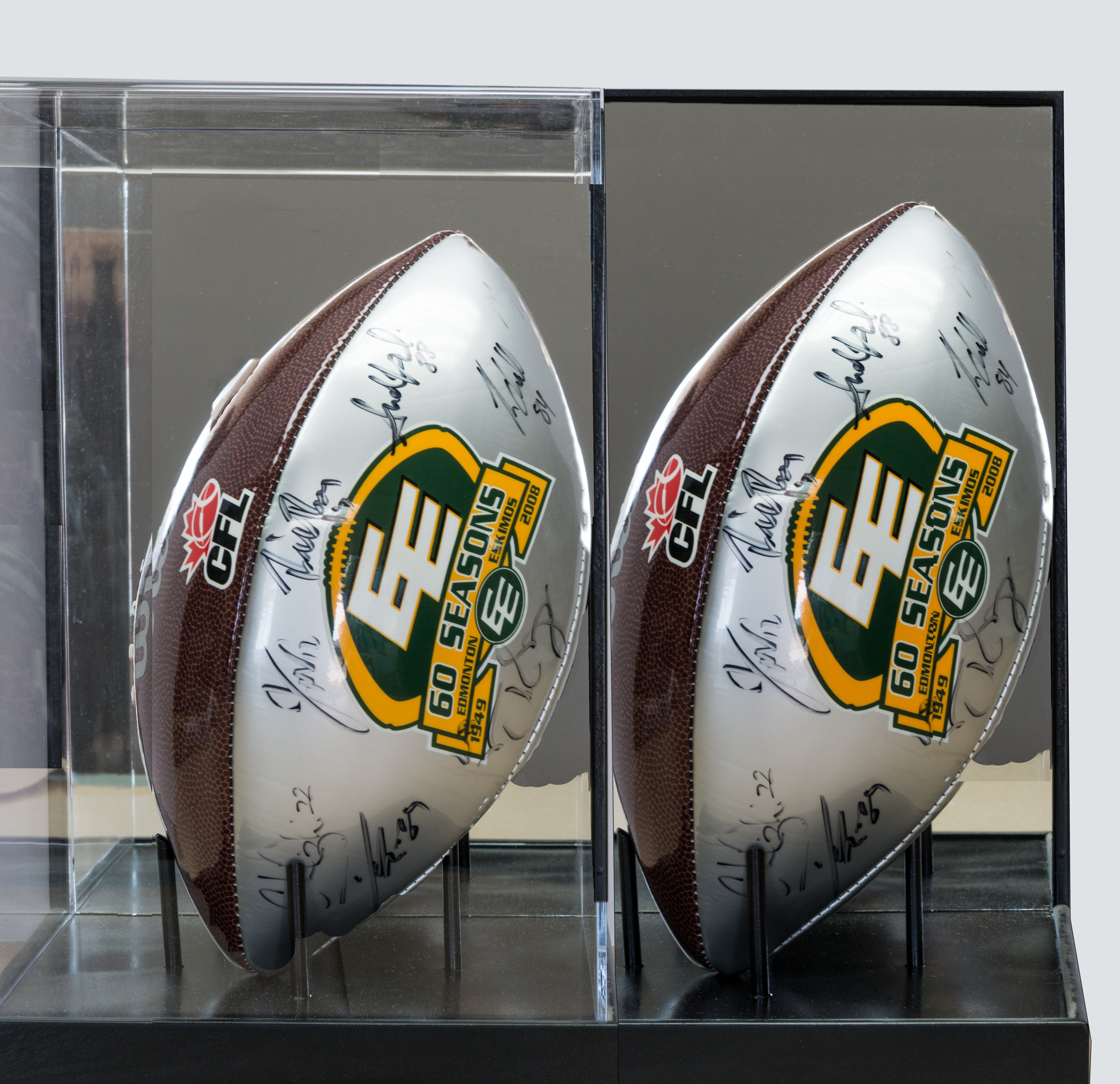 Acrylic box holding autographed Edmonton Eskimo Football