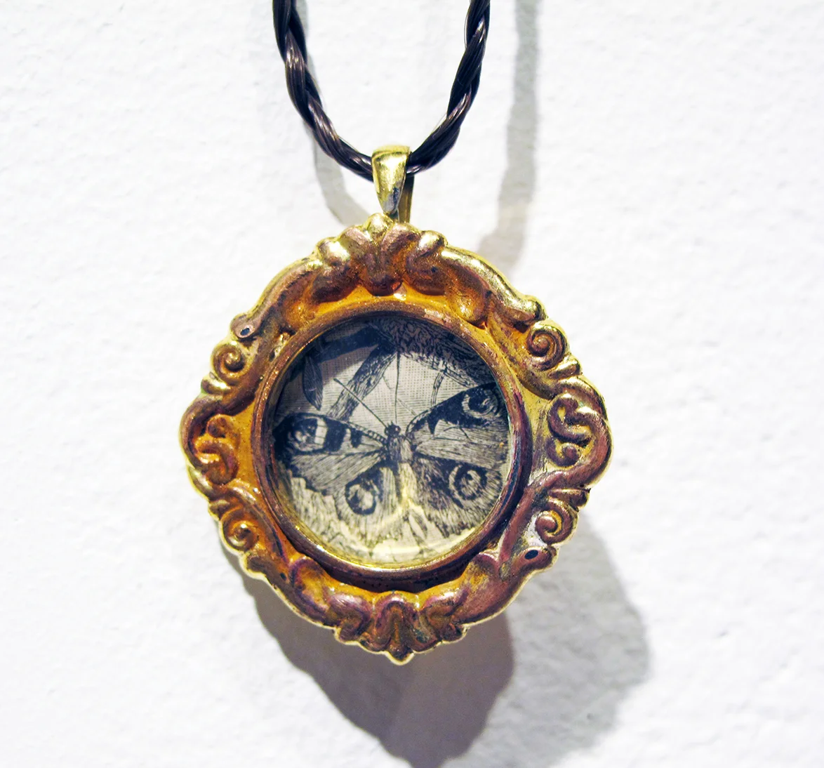 Detail of Reliquary , 2014 | Brass, human hair, paper ephemera