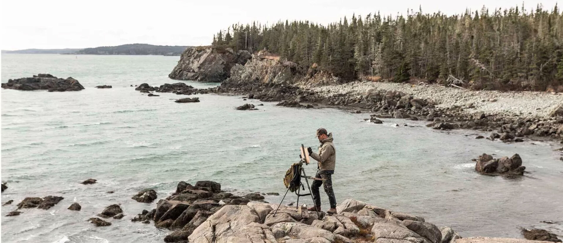  Artist Tim Wilson paints on the Maine Coast as part of a yearlong project documenting the state’s wild places. Photo by Greta Rybus for National Geographic 