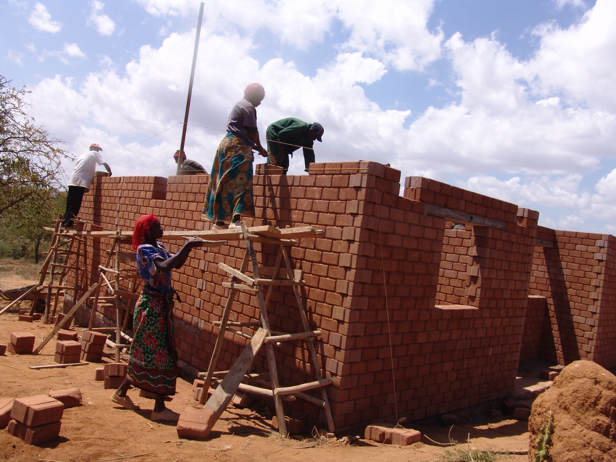 Local community members help build a new family home - Kenya