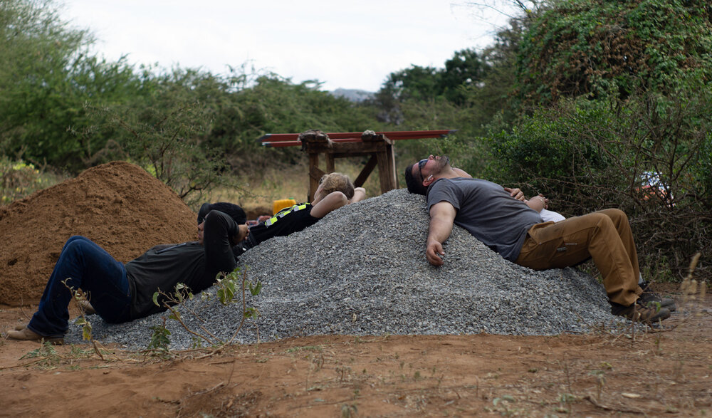 Volunteers find the most comfortable place to take a break after a long day on site