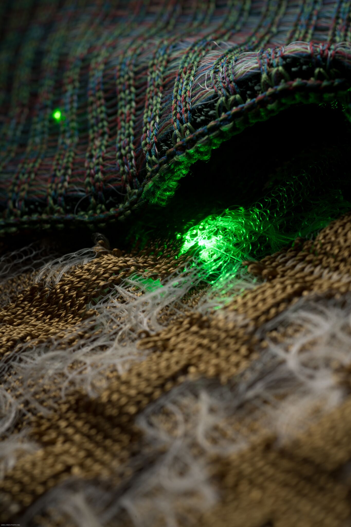 Failure mechanisms of the fibers found by knitting with the LEDs powered by a battery. Most notable failures involve bending radius of fibers, tensile strength, and fiber buckling due to cross section geometry.
