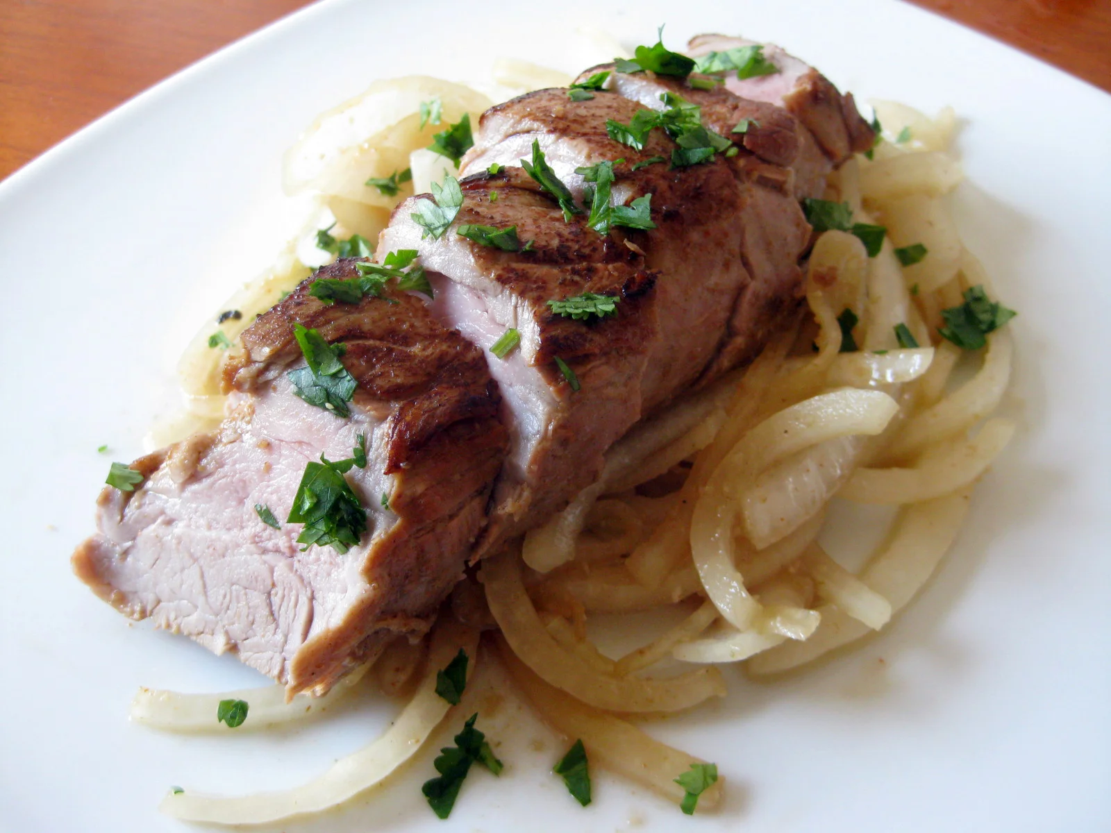 Grilled pork tenderloin over sauteed onions