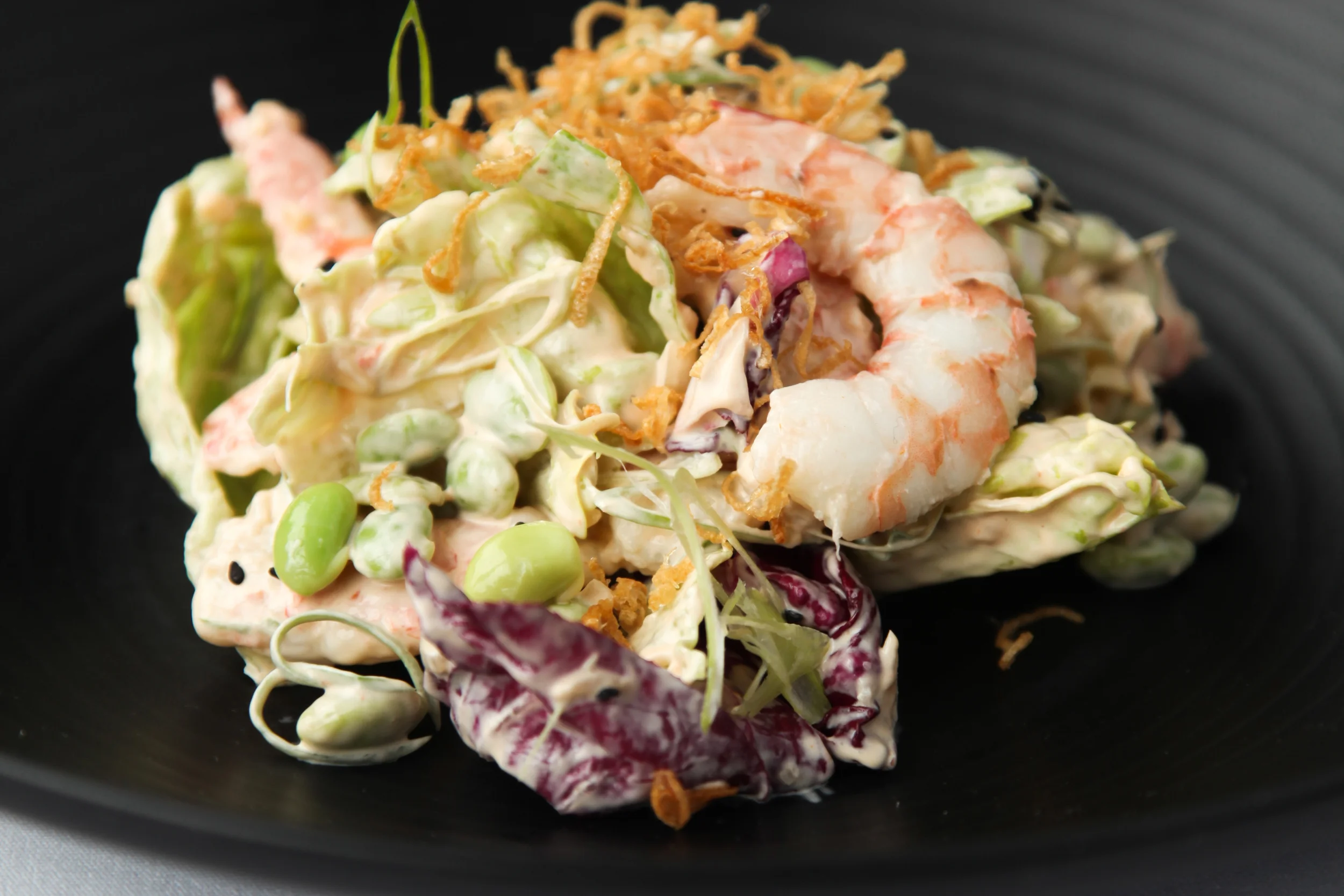 Salad of poached Prawns, iceberg, edamame, spring onion, crispy shallots, Marie Rose dressing & black sesame