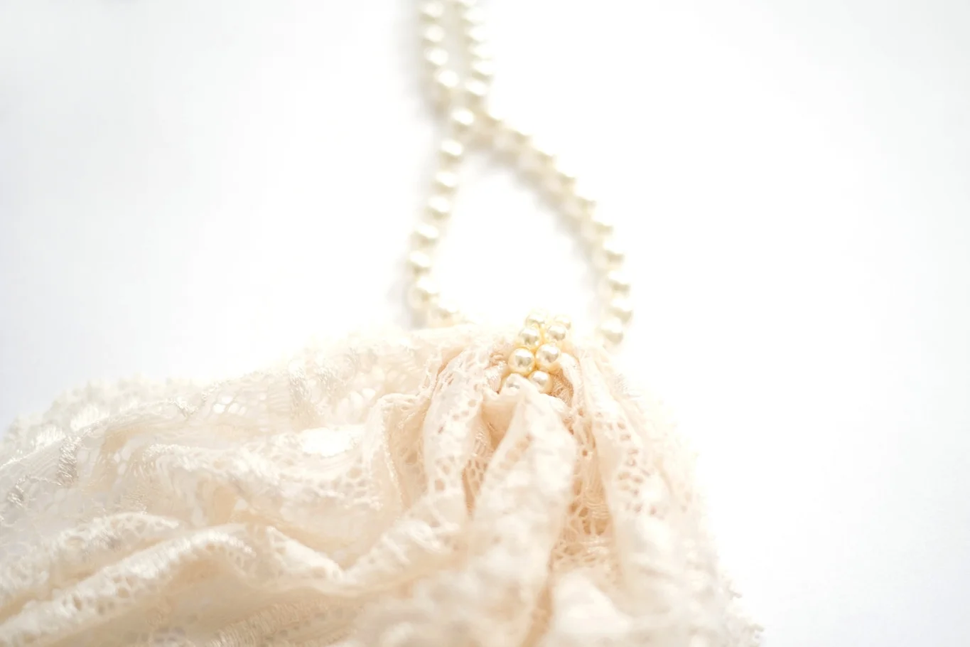 close up of the beautifully soft lace and mallorcan pearls in Ivory