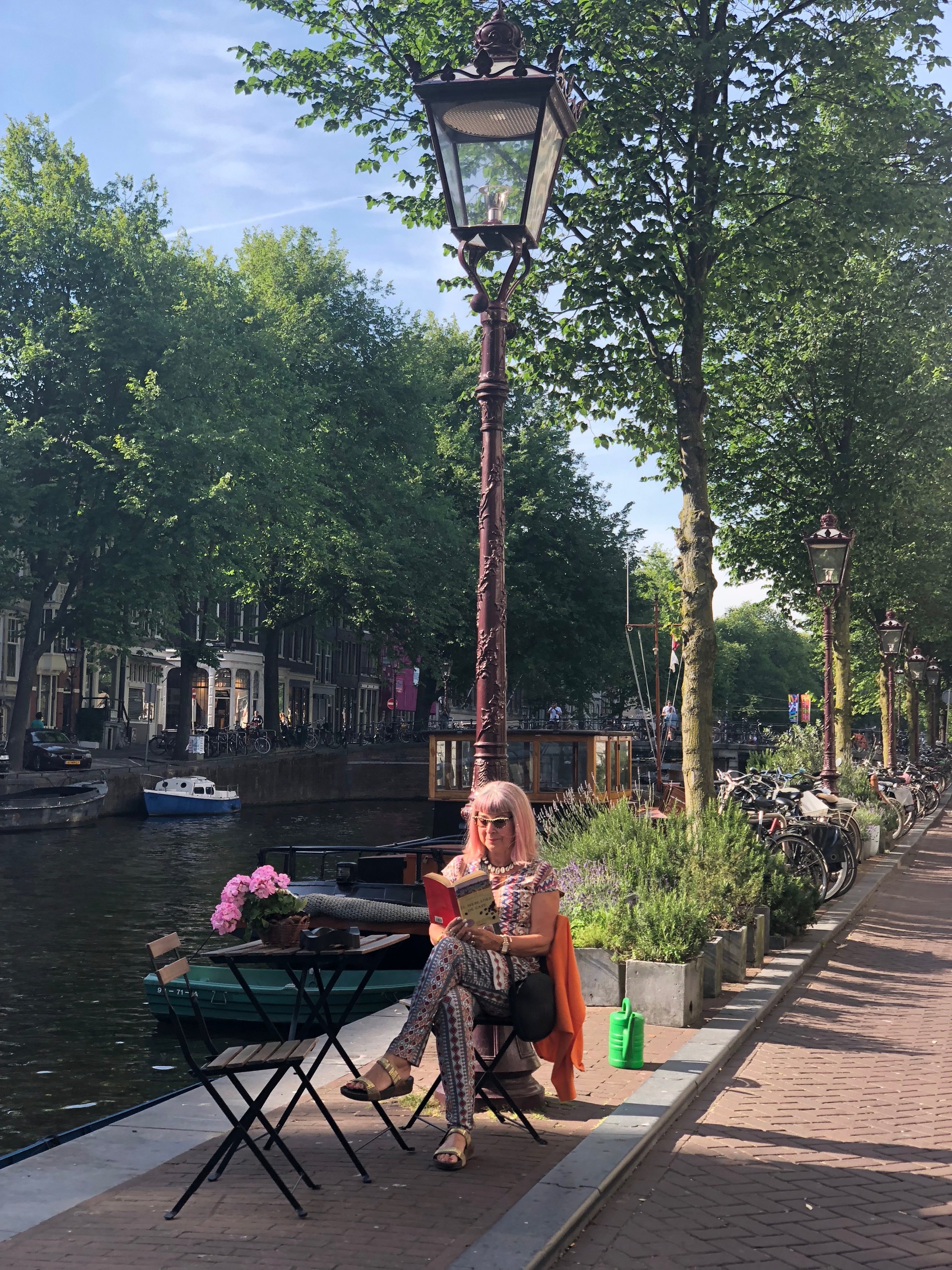 Reading in Amsterdam by a canal