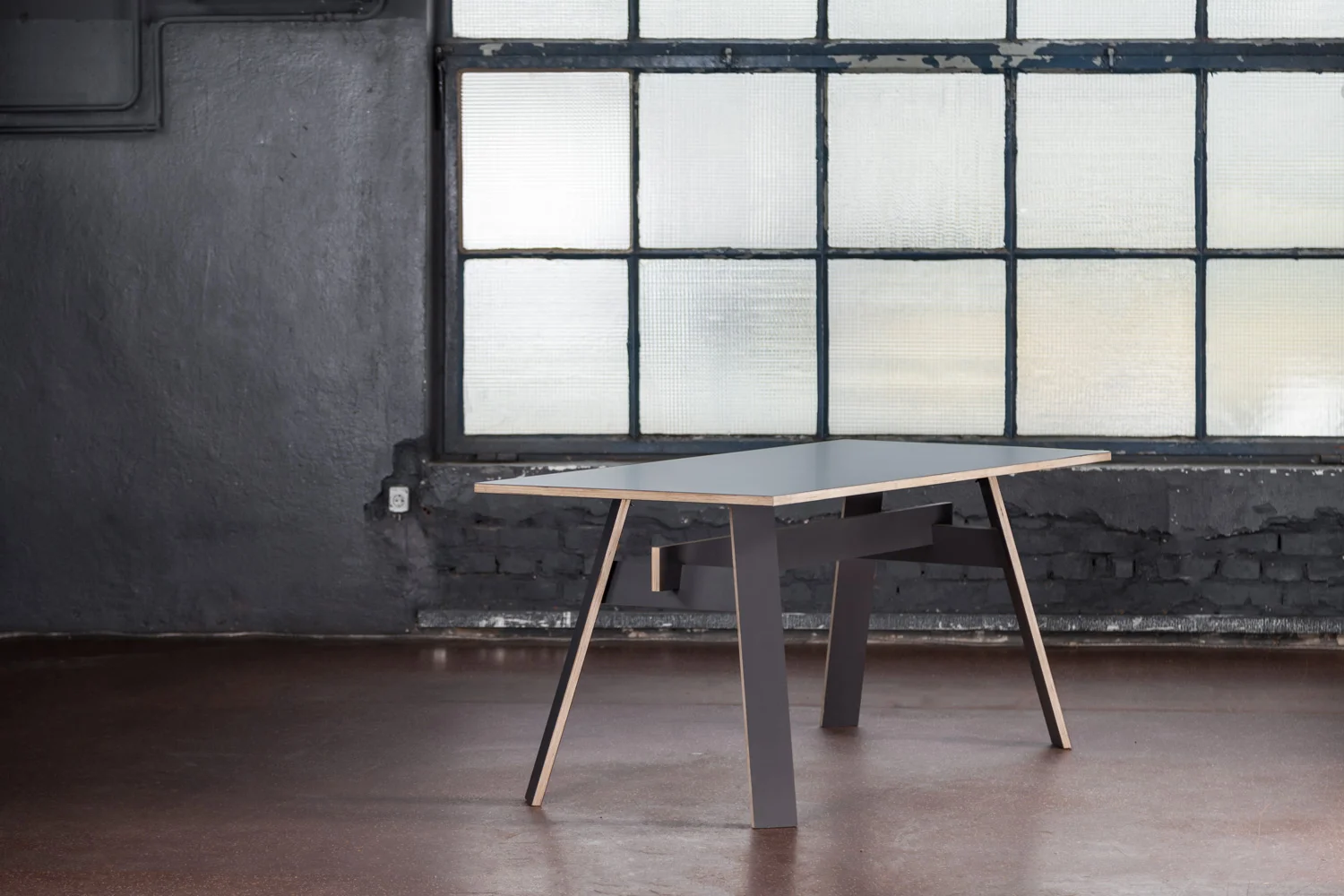The Compound table is entirely made of laminate faced plywood boards. Three elements - trestles, central beam, and tabletop - are wittily tacked together by a simple joining system which allows quick assembling or disassembling and easy transport. Unrefined and honest, Compound delivers exactly what it promises: a no-nonsense and practical table surface.