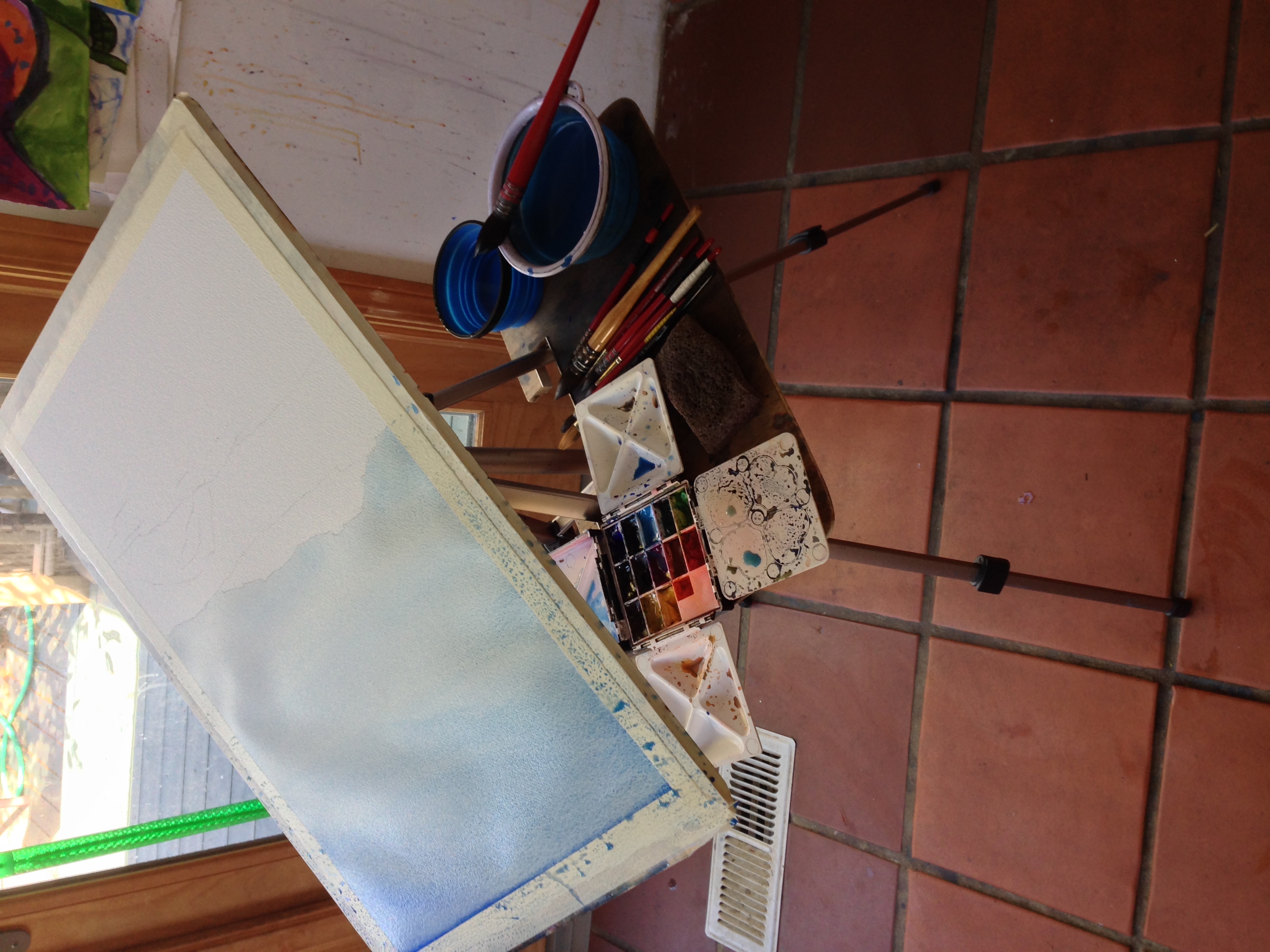 Here I'm painting the sky "upside Down", to get it lighter at the horizon and stop any drips from happening.