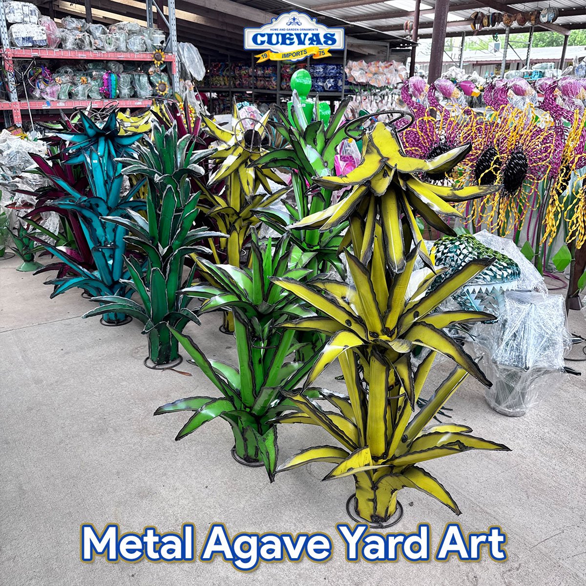 Colorful metal yard art sculptures resembling various plants, displayed outdoors for sale at a garden store.