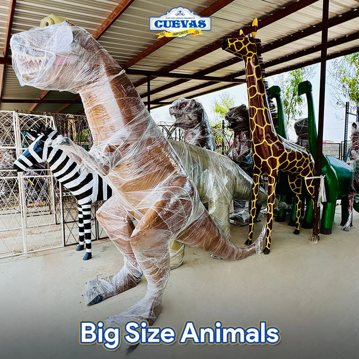 Display of large inflatable animal toys, including a giraffe, a dinosaur, a zebra, and a T-Rex, at a store with a metal roof and outdoor setting.