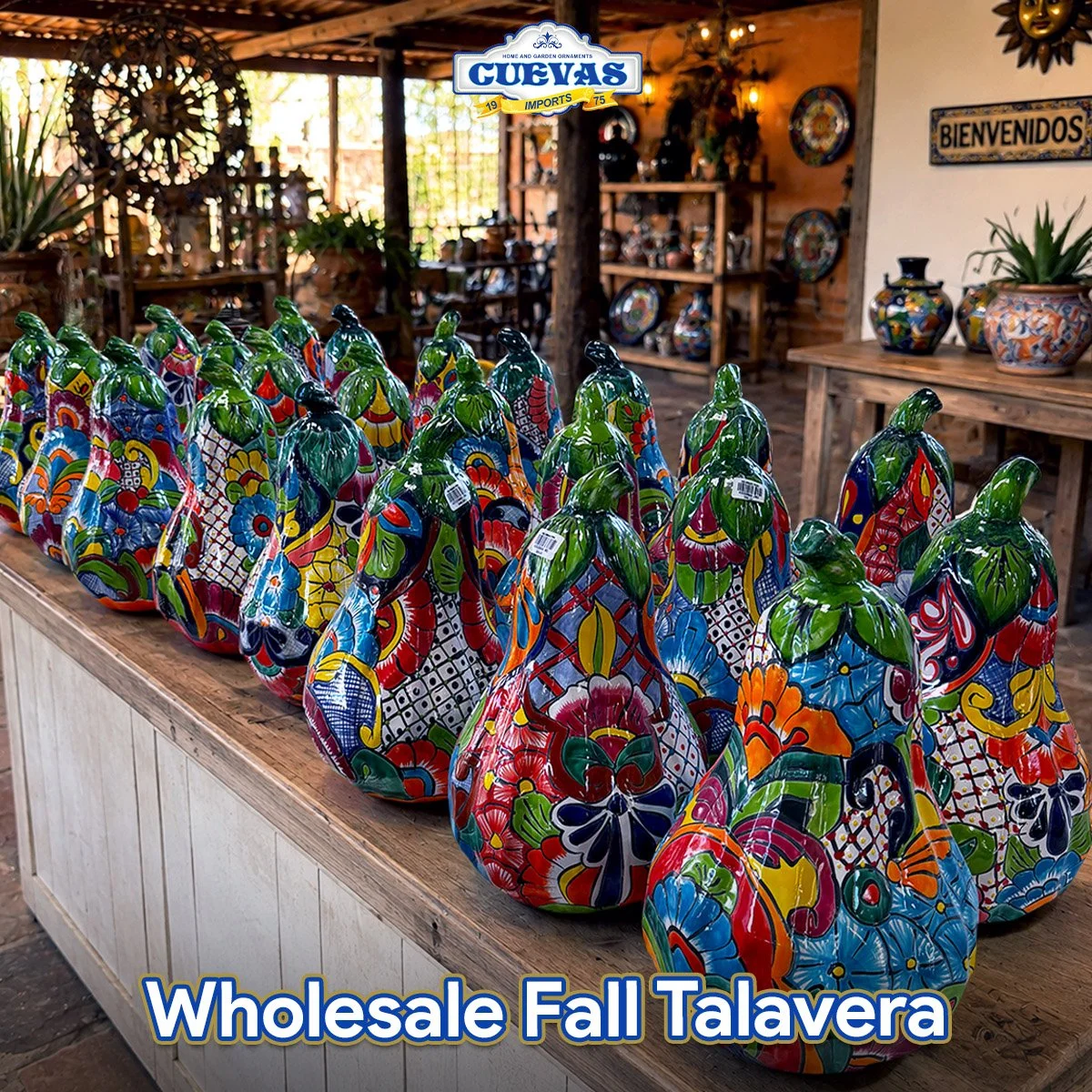 Colorful painted ceramic gourds displayed on a wooden table at a Mexican pottery store.