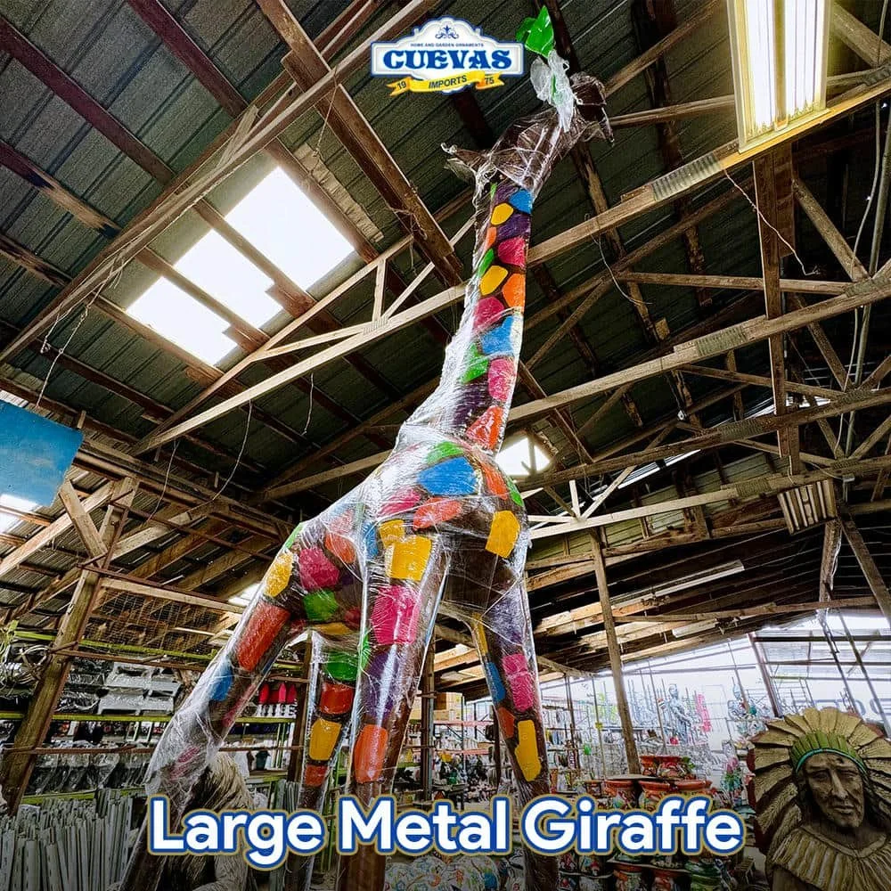 Large metal giraffe covered in colorful candy-like decorations inside a store.