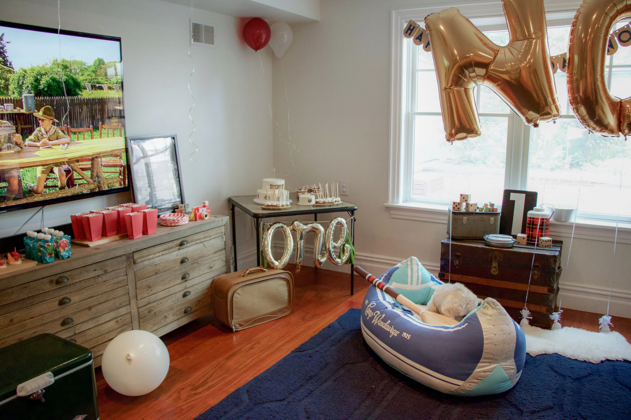 Steel Cooler: Coleman , Plush Canoe: Land of Nod , Wooden Dice: Michaels , Camera: Fisher-Price Classics , 'one' balloon: Oh Shiny Paper Co. , NOAM ballons: Paperboy Party , Happy Birthday banner: When It Rains Paper