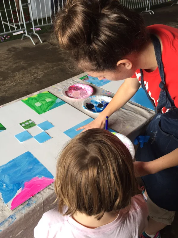 Julie helping a young artist get started at the Pullman Yard Showcase.