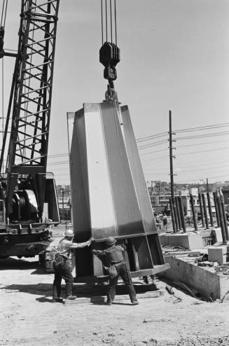 Workers_guiding_base_of_Space_Needle_leg_into_place_ca_June_30_1961.jpg