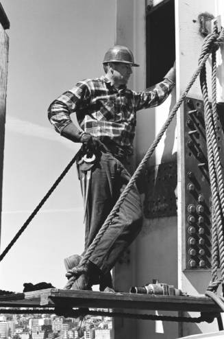 Worker_stands_on_construction_float_off_of_Space_Needle_leg_ca_September_8_1961.jpg