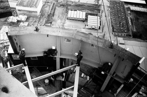 Workers_install_Space_Needle_ring_girder_with_Armory_below_ca_November_1924_1961.jpg