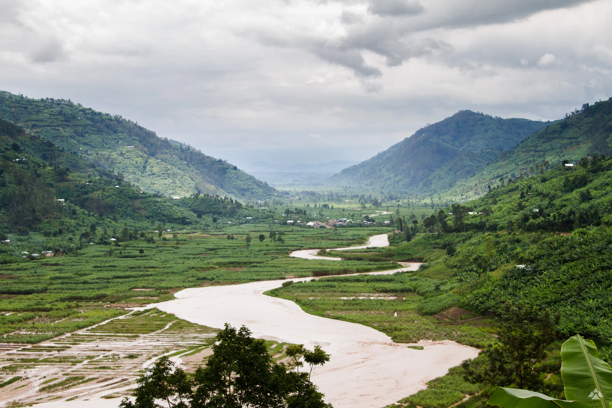 Views across the surrounding mountains of Shyira. Heavy rainfall had burst the banks of the river that meanders through.