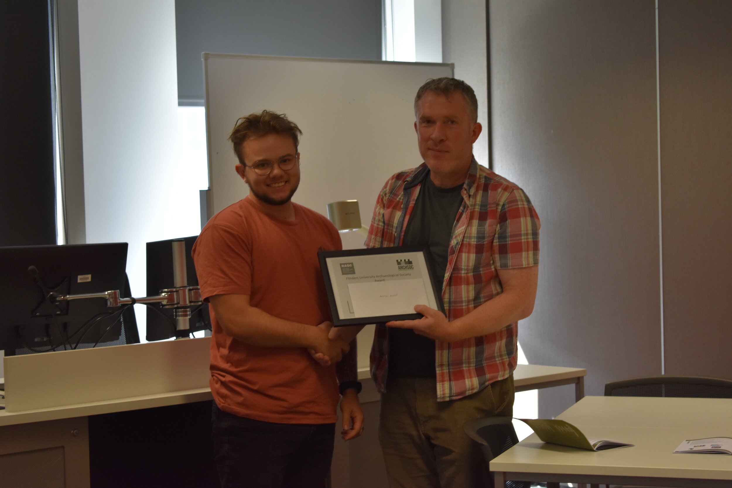 Isaac Roberts, Recipient of the Flinders Archaeological Society Award for the most promising research at NASC 2019, receiving from Richard Osgood