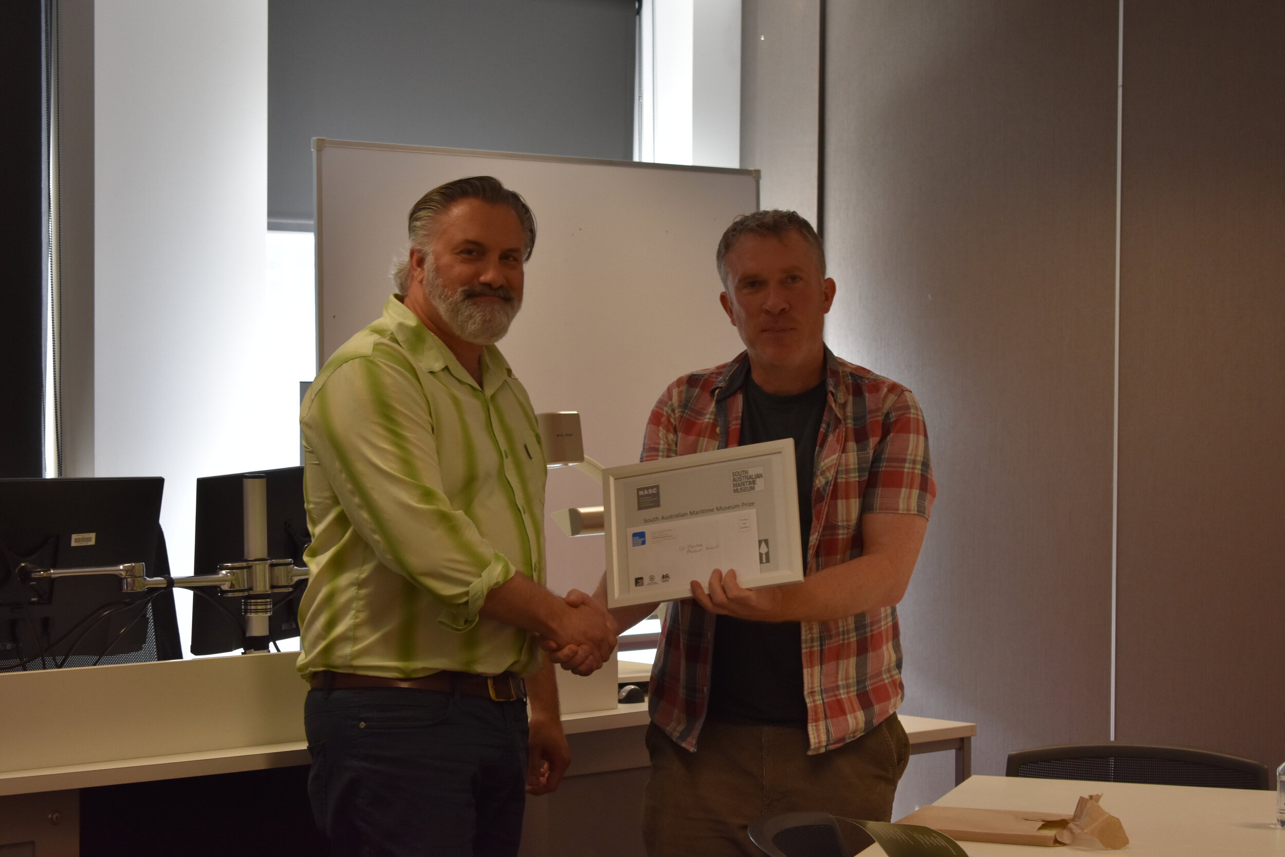 Mick de Ruyter, Flinders University, Recipient of the SA Maritime Museum Prize for an outstanding poster at NASC 2019, accepting from Richard Osgood