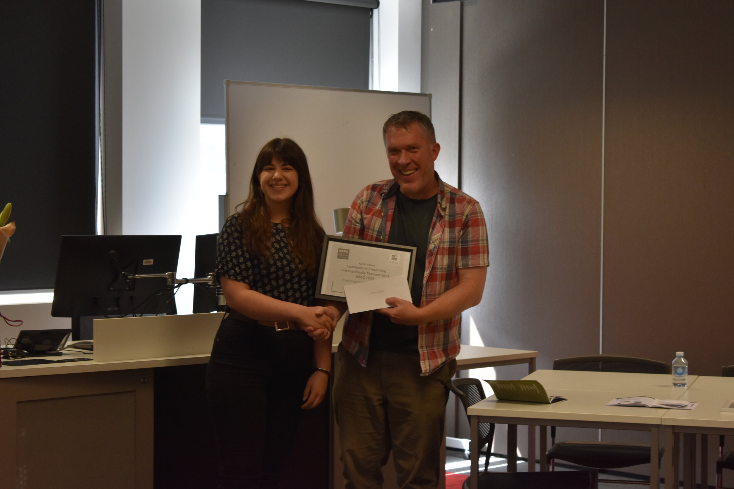Iona Claringbold, Recipient of the Australian Society for Historical Archaeology Award for excellence in presenting internationally themed research, receiving from Richard Osgood