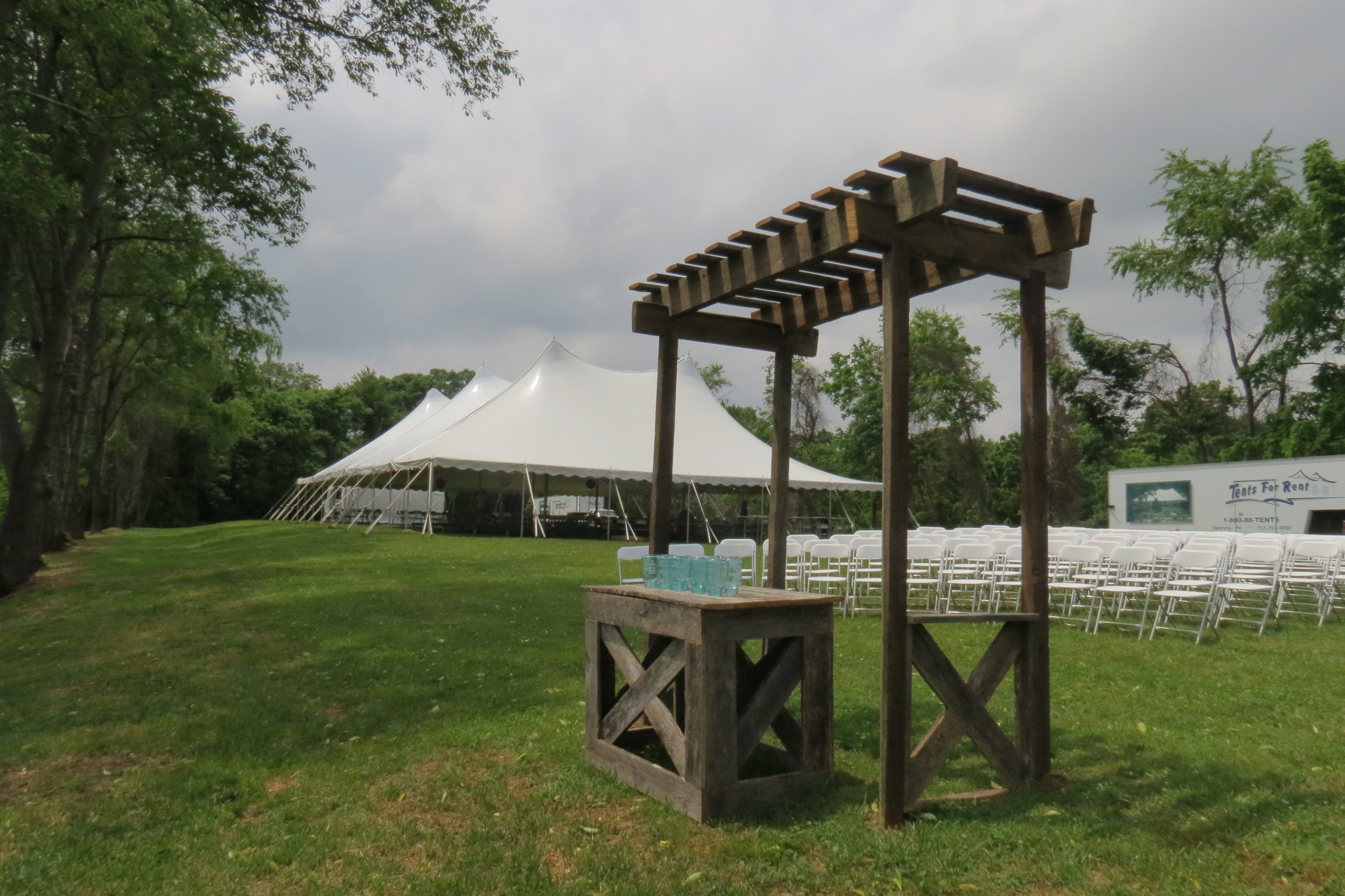 White wedding tent and white folding chairs