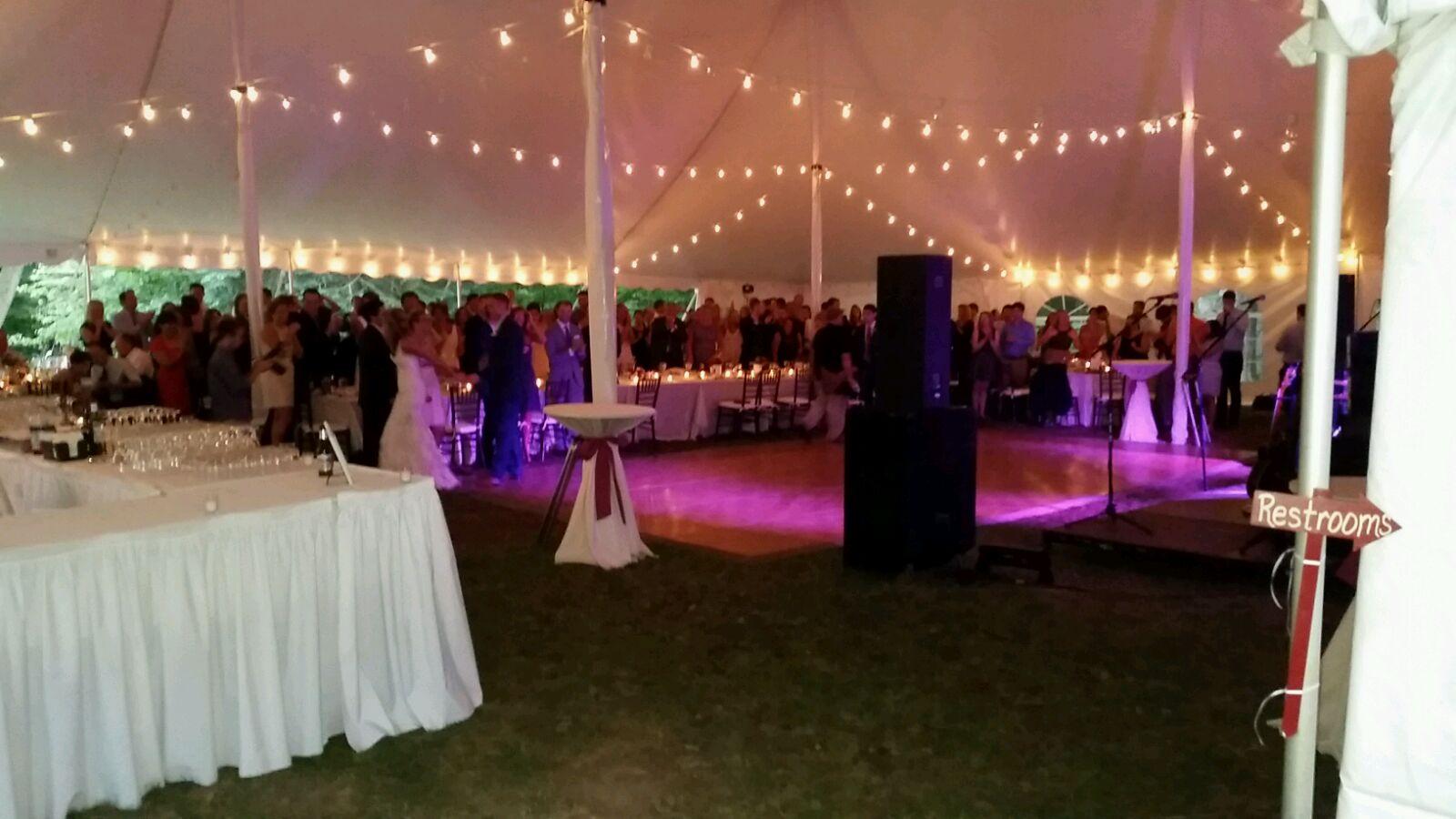 White wedding tent with cafe lights and dance floor
