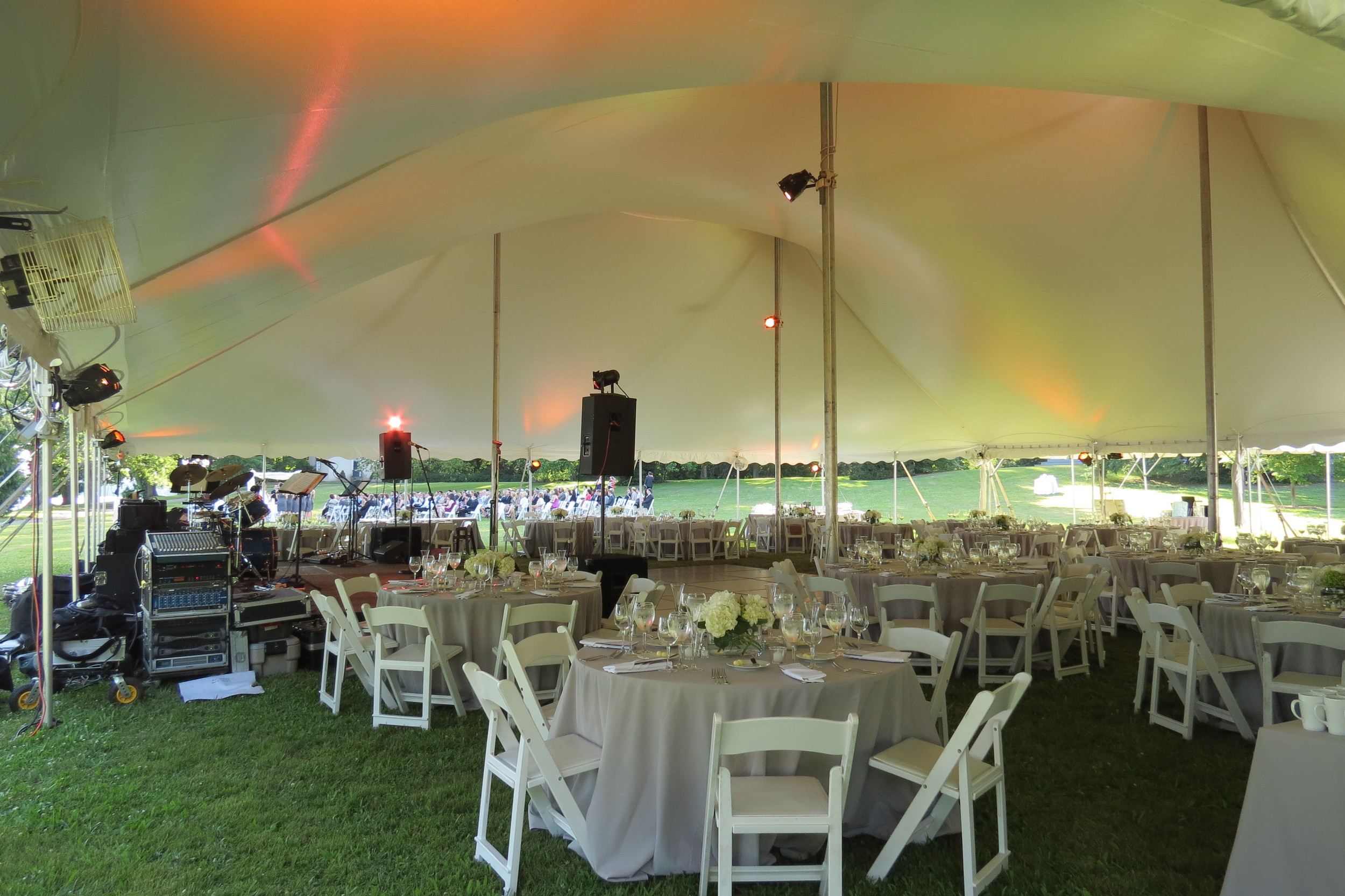 White padded chairs and 60" round tables