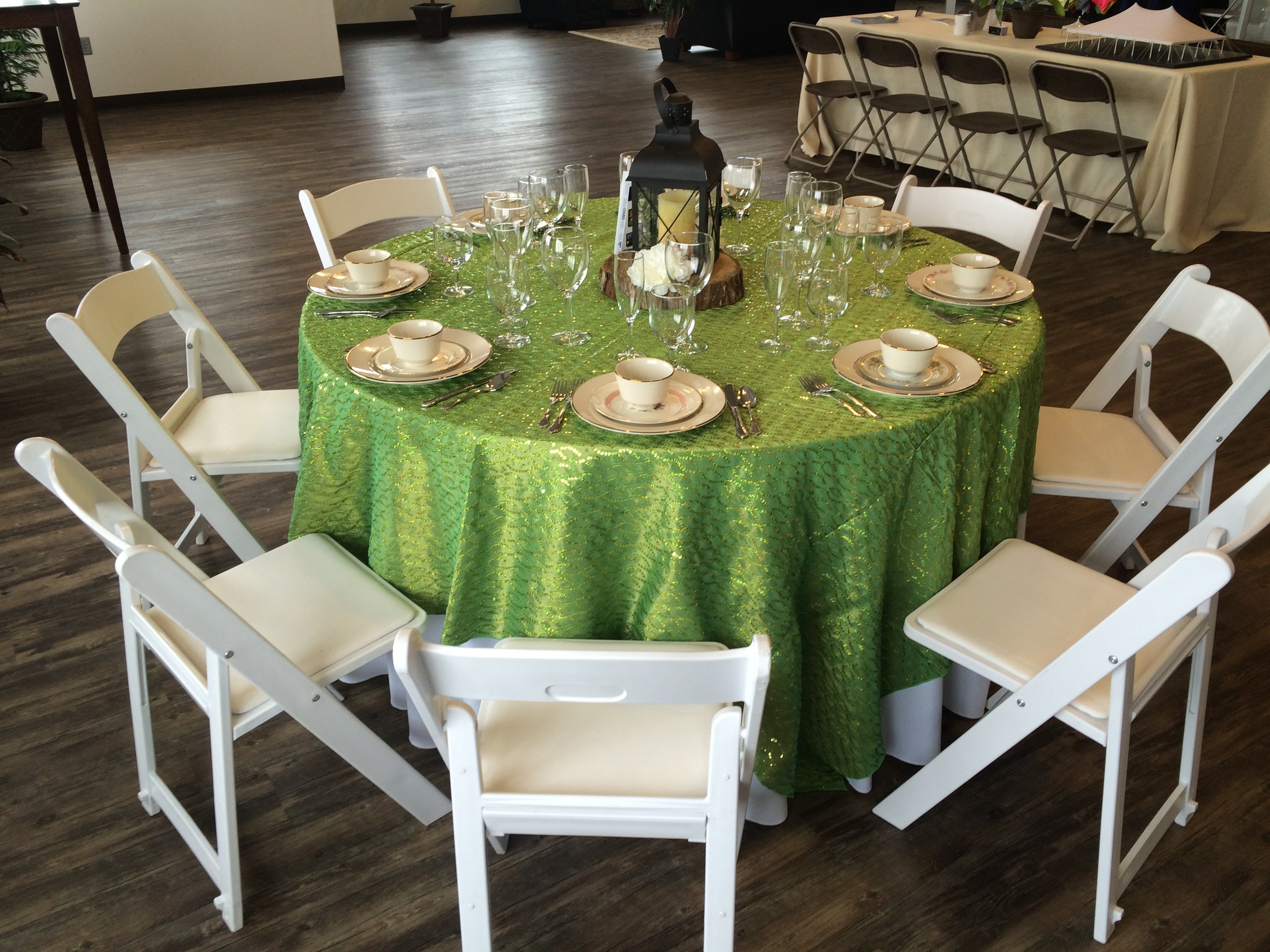 White padded chairs and 60" round table