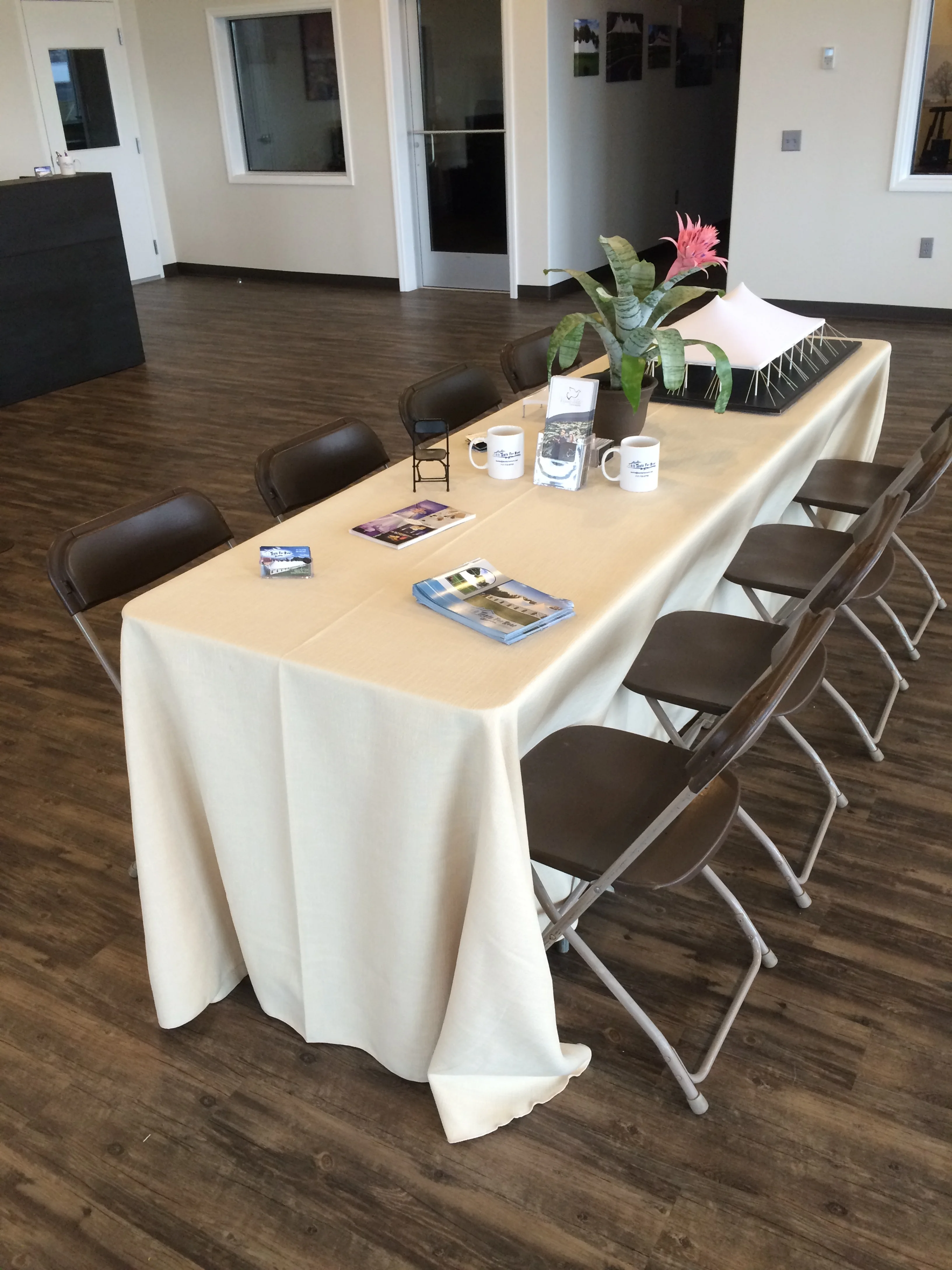 Brown folding chairs at 8' rectangular table