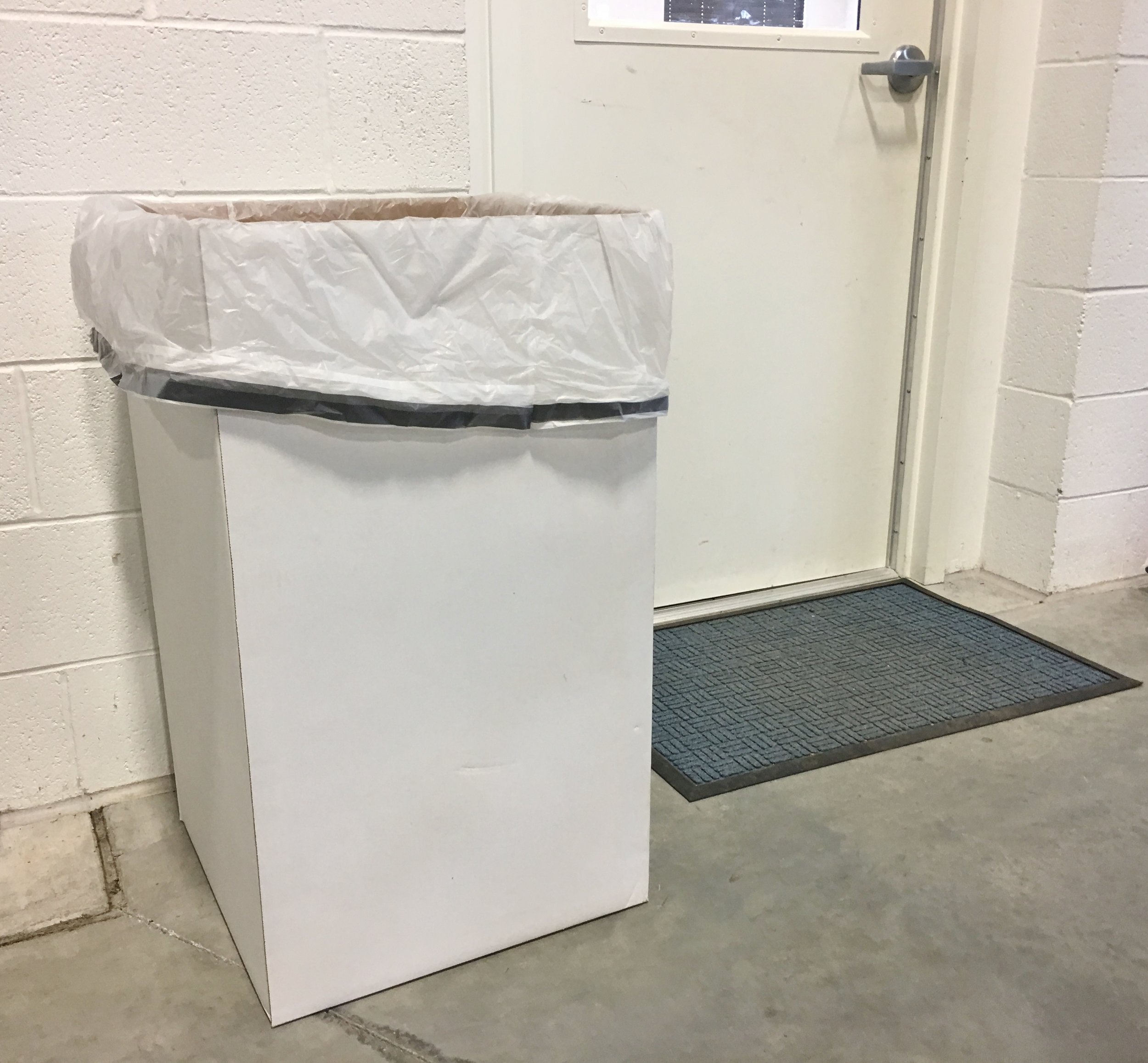 Cardboard disposable trash can with 55 gallon liner