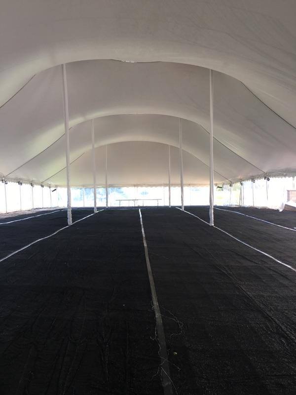Black carpet in outdoor event tent
