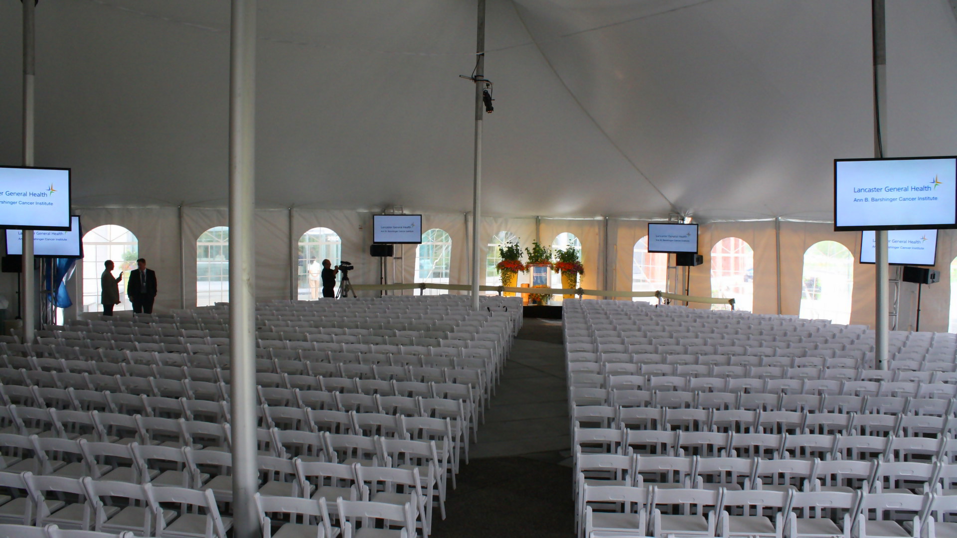 Beautiful, white tent with white chairs and cathedral window side walls