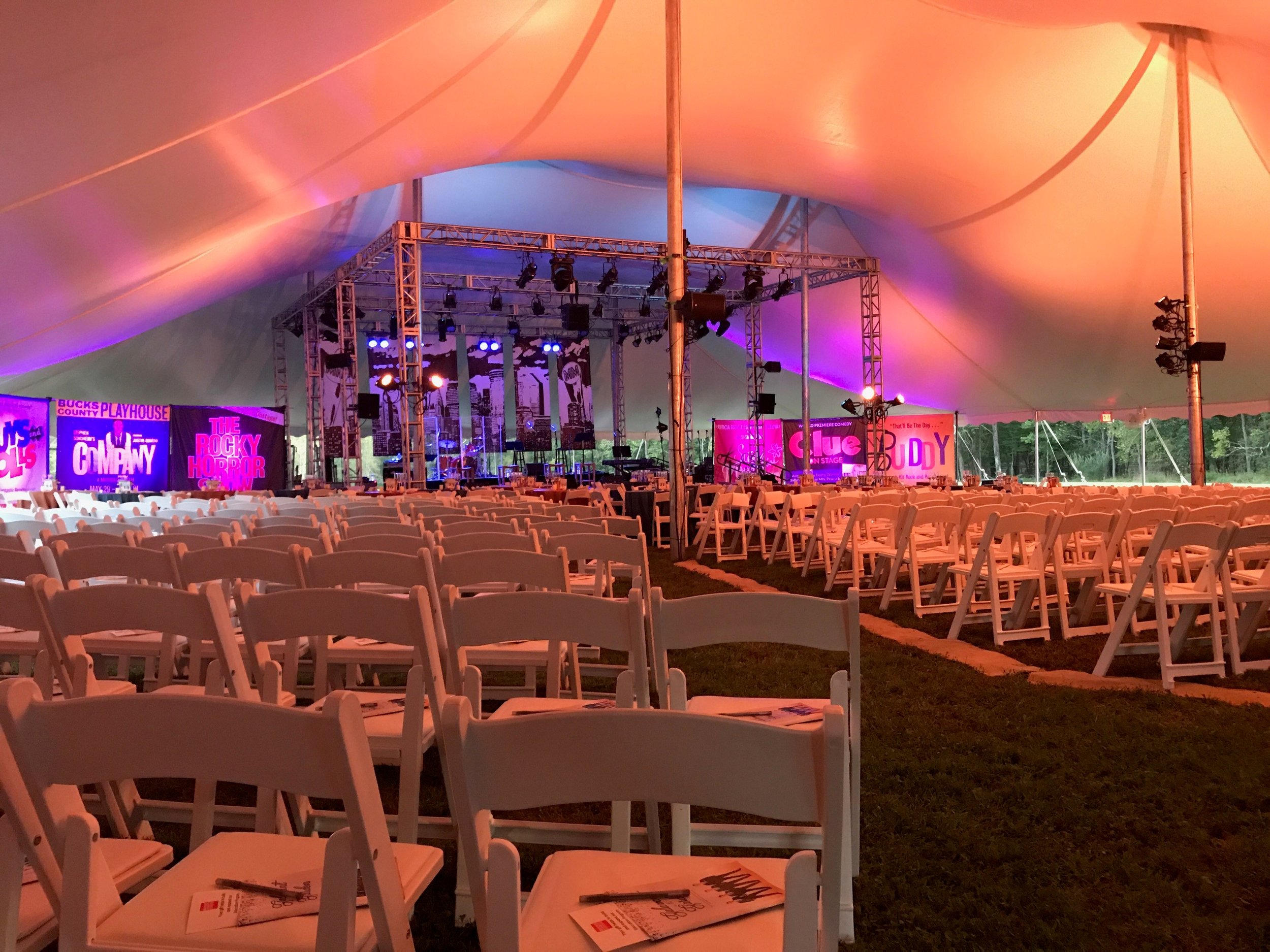 White padded chairs for tent wedding ceremony 