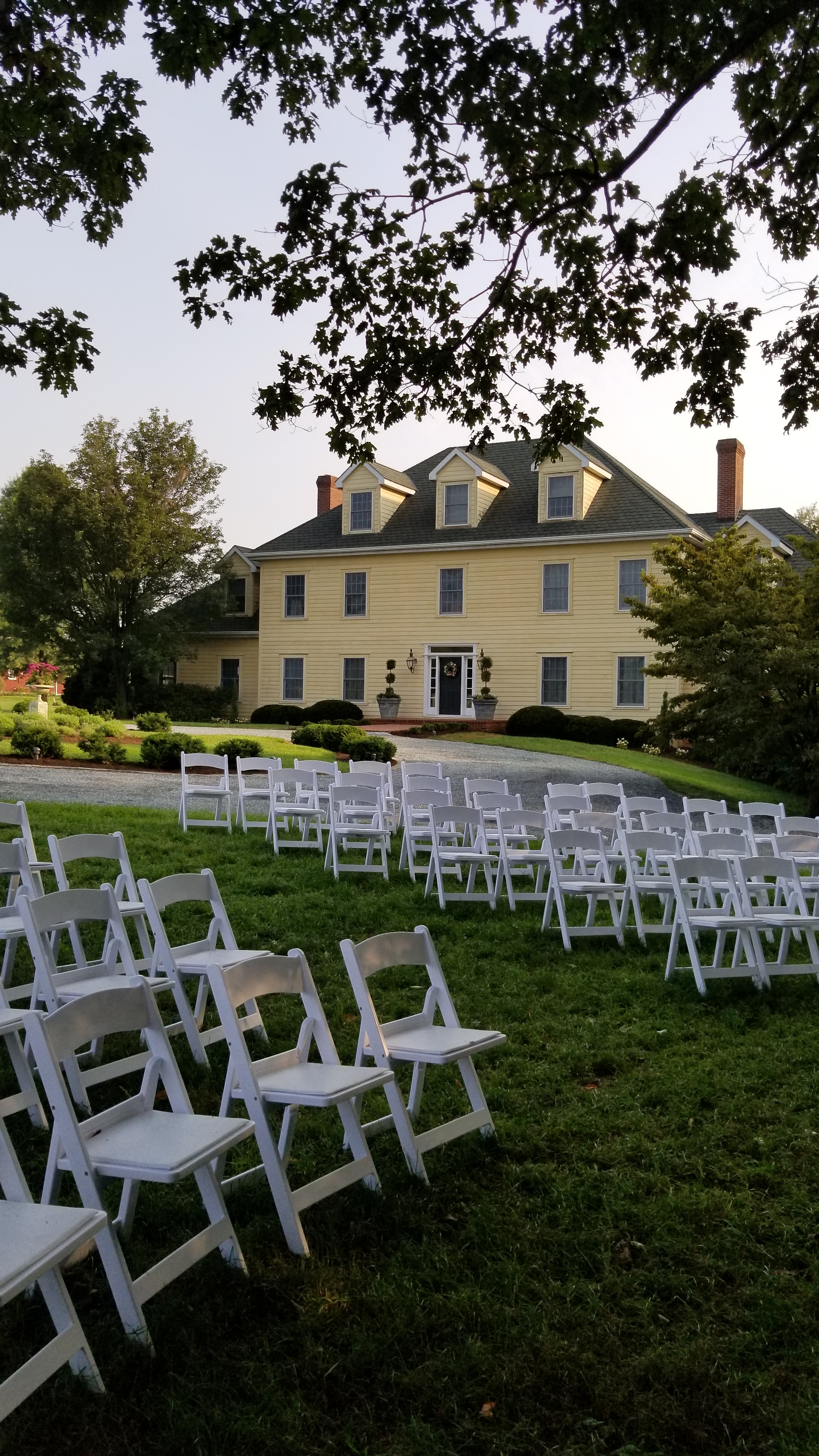 White padded chairs for outdoor wedding