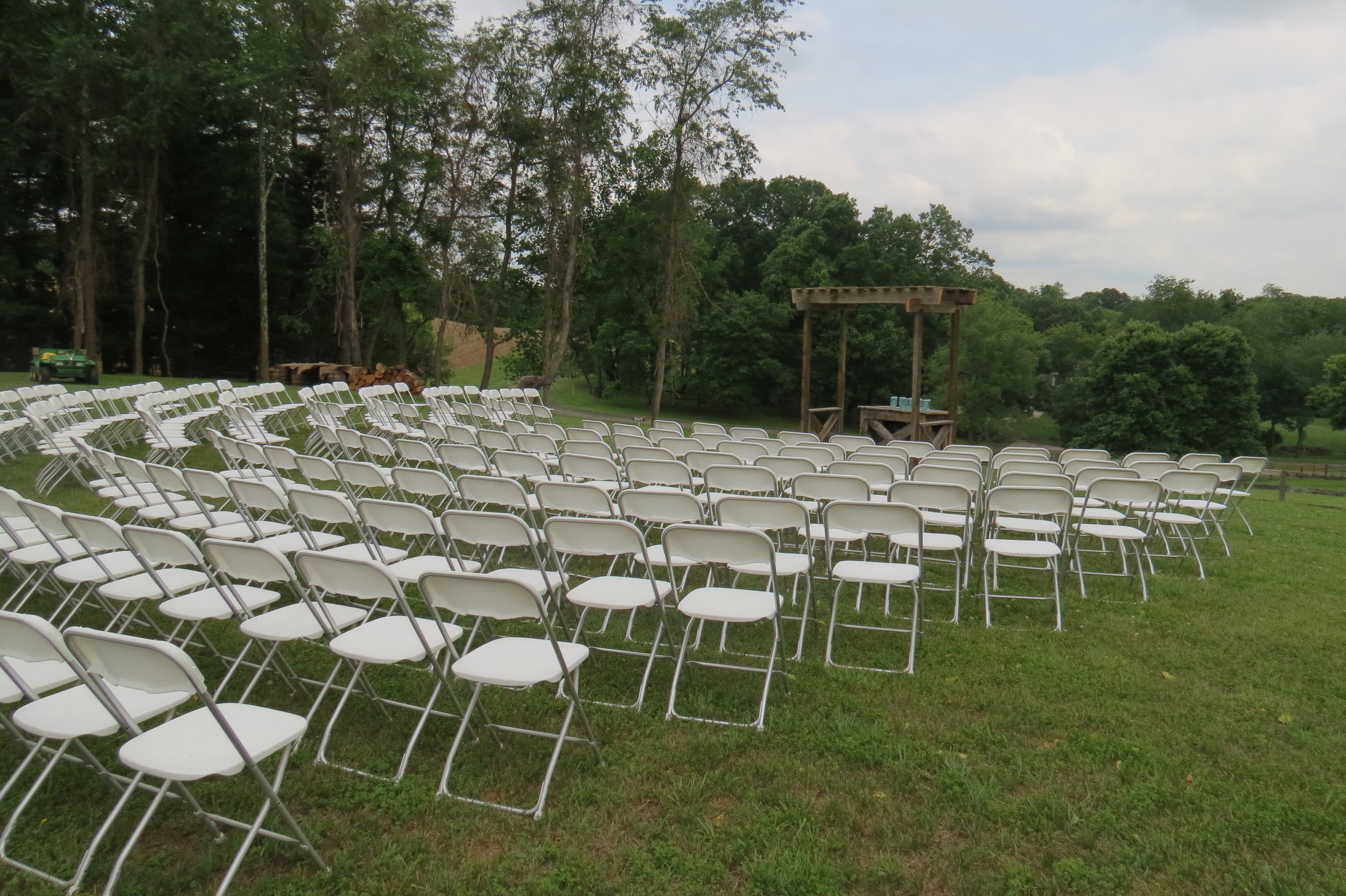 White folding chairs to rent for your outdoor ceremony
