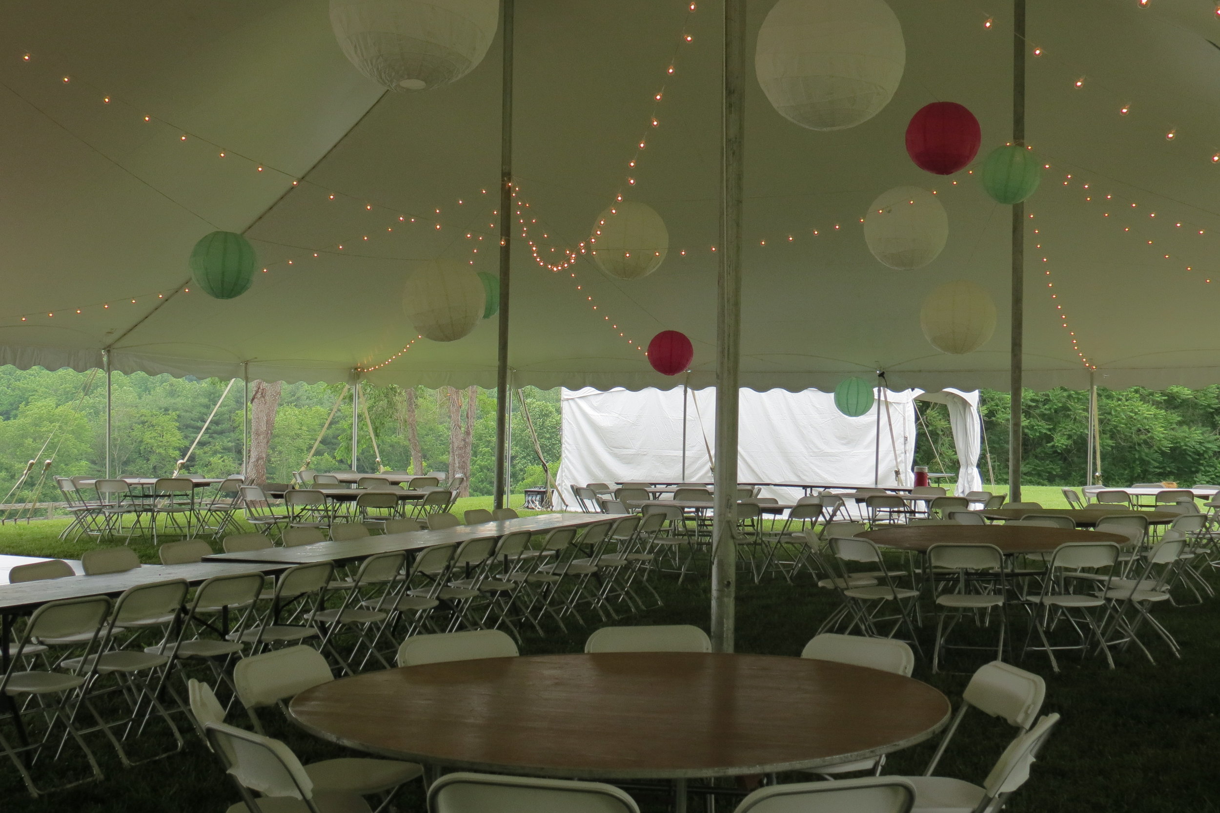 Pole tents with cafe lighting and tables and chairs for your special tent wedding