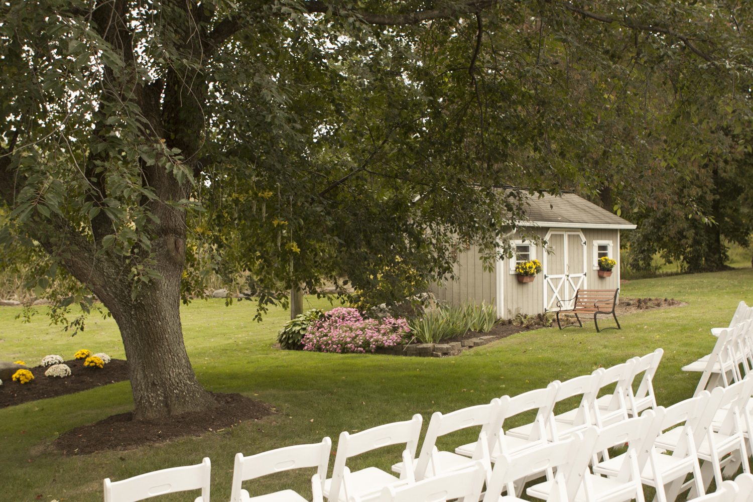 White padded folding chairs for your outdoor wedding ceremony