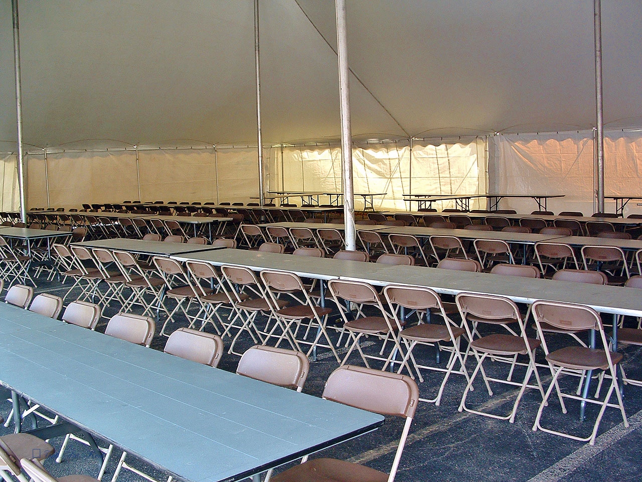 Brown chairs and long tables for your pole tent events