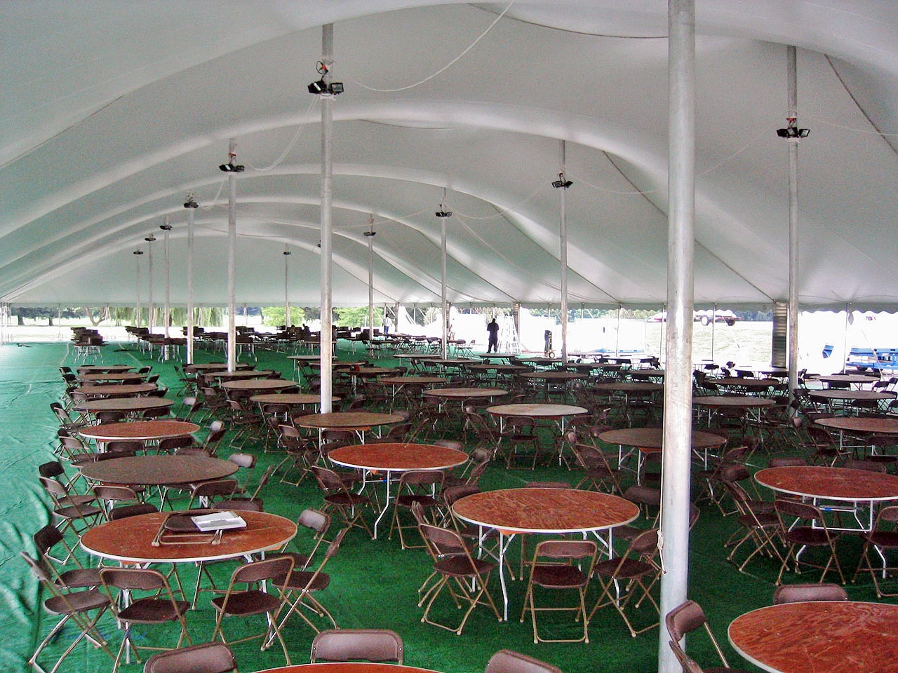 Brown chairs, round tables and flooring to rent for your tent event